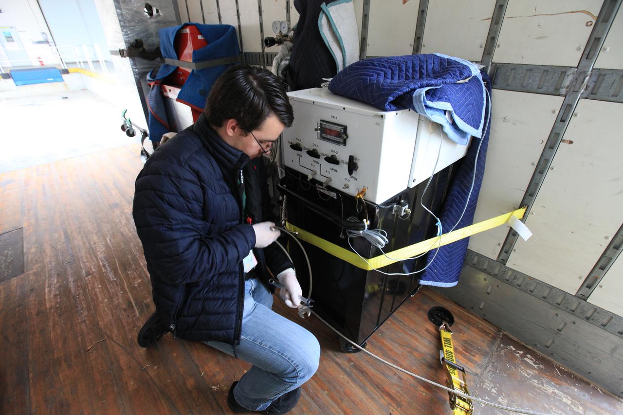 Kevin Mark, Orbiting Carbon Observatory 3 (OCO-3) purge engineer with NASA’s Jet Propulsion Laboratory, fastens a separate fixture of OCO-3, stored apart from its payload container, to a truck for transport from the Space Station Processing Facility high bay at the agency’s Kennedy Space Center in Florida to the SpaceX facility on March 18, 2019. The OCO-3 payload will be stowed in the trunk of SpaceX’s Dragon spacecraft, where it will launch aboard a Falcon 9 rocket on the company’s 17th Commercial Resupply Services mission to the International Space Station. Launch is scheduled for April 25, 2019, from Launch Complex 40 at Cape Canaveral Air Force Station. Once the payload reaches the station, it will be removed from Dragon and robotically installed on the exterior of the orbiting laboratory’s Japanese Experiment Module Exposed Facility Unit, where it will measure and map carbon dioxide from space to provide further understanding of the relationship between carbon and climate. 