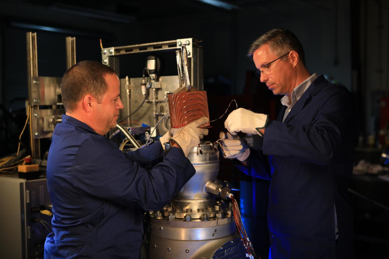 Mark Velasco (left) and Jared Sass assemble a custom cold heat exchanger for freezing carbon dioxide from a simulated Martian environment in the Cryogenics Test Laboratory at NASA's Kennedy Space Center on Mar. 20, 2019.