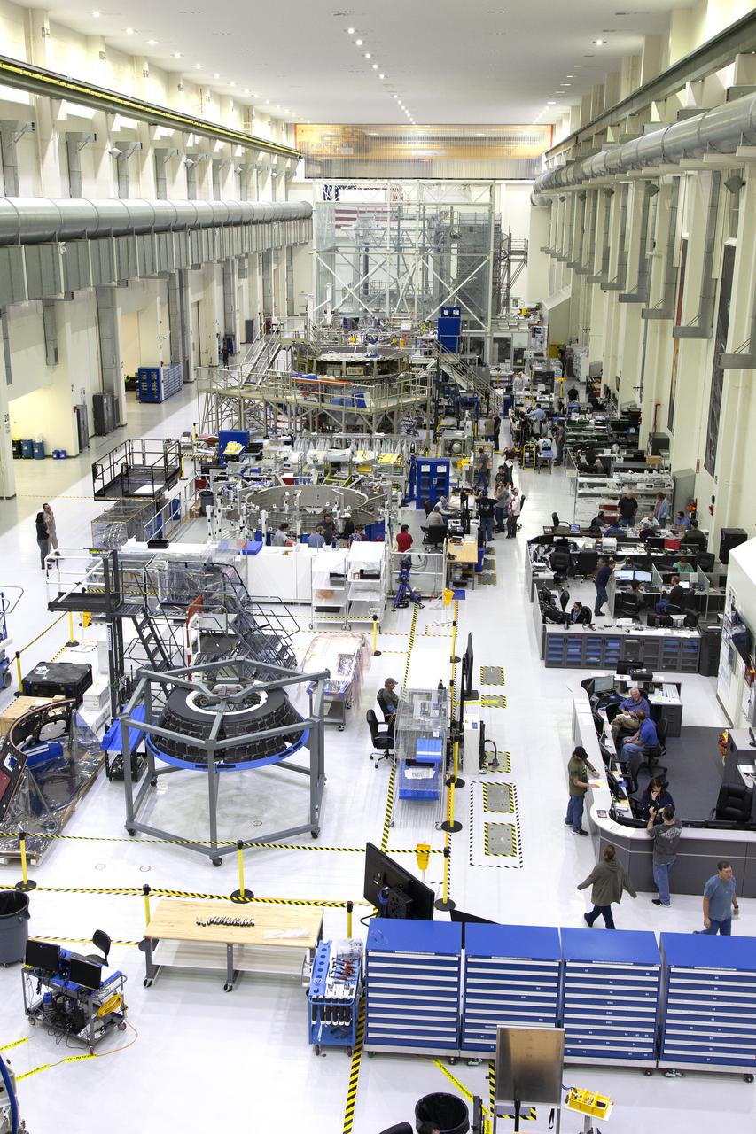 The Neil Armstrong Operations and Checkout Building high bay is filled with various pieces of flight hardware for Exploration Mission-1 (EM-1) and Exploration Mission-2 (EM-2) at NASA’s Kennedy Space Center in Florida. In this view taken on March 21, 2019, the forward bay cover for Orion (EM-1) is at far left in the foreground. Just to its right is the bay cover (EM-1). Behind these two pieces is the crew module adapter for EM-2. Further back, secured on a test stand is the European Service Module that will serve as the powerhouse for Orion. For EM-1, Orion will launch atop the Space Launch System rocket from Launch Pad 39B. The spacecraft will travel thousands of miles past the Moon on an approximately three-week test flight. Orion will return to Earth and splashdown in the Pacific Ocean off the coast of California, where it will be retrieved and returned to Kennedy.