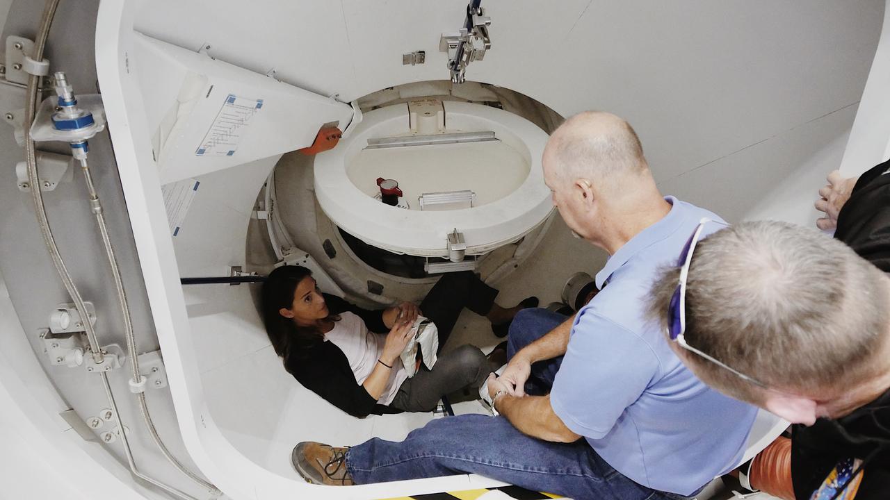 NASA astronaut Nicole Mann, assigned to fly in the Crew Flight Test of Boeing’s CST-100 Starliner, practices opening a mockup of the spacecraft hatch on the International Space Station’s International Docking Adapter at NASA’s Johnson Space Center in Houston, Texas. Boeing’s Crew Flight Test is part of NASA’s Commercial Crew Program, which is working with Boeing to return human spaceflight launches to the space station from U.S. soil.