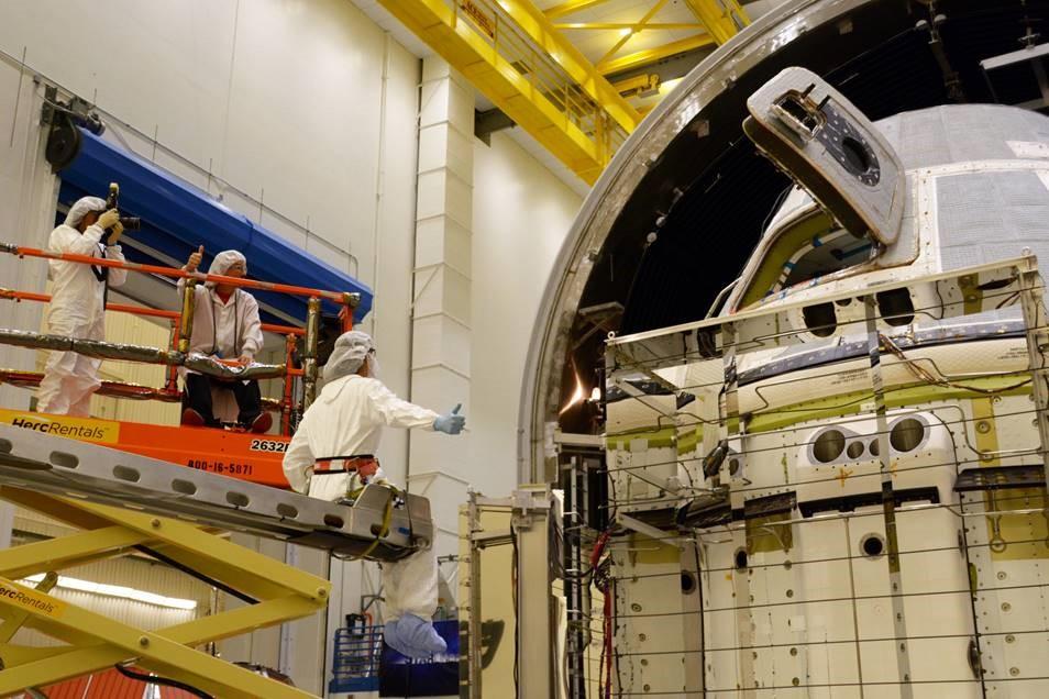 NASA astronaut Suni Williams (seated), assigned to Boeing’s first operational mission aboard the company’s CST-100 Starliner spacecraft, watches as Boeing test teams outfit Starliner with hot plates and radiators ahead of the thermal vacuum test series at Boeing’s Space Environment Test Facility in El Segundo, Calif. NASA’s Commercial Crew Program is working with Boeing to return human spaceflight launches to the space station from U.S. soil.