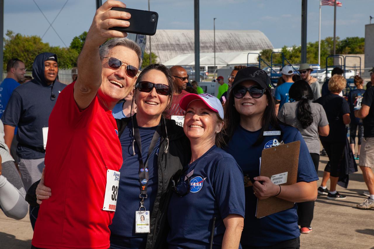 Kennedy Space Center employees and guests pose for a selfie with Center Director Bob Cabana prior to the start of the Florida spaceport’s annual KSC Walk Run on March 26, 2019. Part of Kennedy’s Safety and Health Days, the event takes place at the Shuttle Landing Facility runway and offers participants the chance to partake in a two-mile walk or run, a 5K or a 10K. 