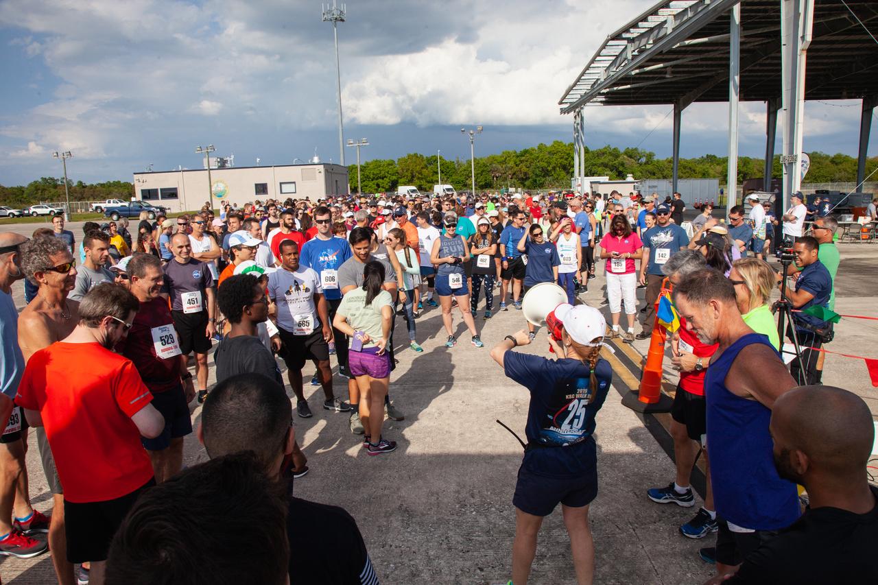 A speaker addresses Kennedy Space Center employees and guests prior to the start of the Florida spaceport’s annual KSC Walk Run on March 26, 2019. Part of Kennedy’s Safety and Health Days, the event takes place at the Shuttle Landing Facility runway and offers participants the chance to partake in a two-mile walk or run, a 5K or a 10K. 
