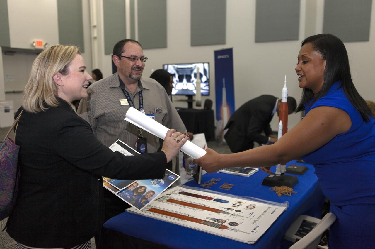 Guests visit with a representative from Boeing before NASA Kennedy Space Center Director Bob Cabana’s update to community leaders, business executives, partners, educators and government leaders March 29, 2019, at the Kennedy Space Center Visitor Complex in Florida. Cabana’s presentation covered recent accomplishments and future plans for Kennedy-led programs, including the Commercial Crew Program, Exploration Ground Systems, Launch Services Program, Exploration Research and Technology, and Center Planning and Development. After the presentation, guests had the opportunity to ask questions and visit displays from the programs and some of the commercial partners.