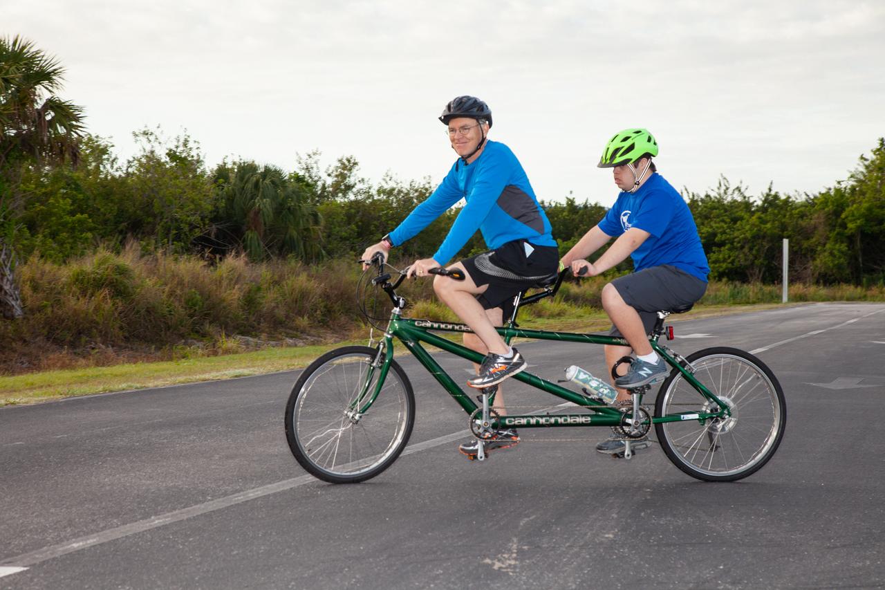 Participants riding a tandem bicycle take part in Kennedy Space Center’s annual Tour de KSC. The bicycle tour took place March 30, giving Kennedy employees and guests the opportunity to choose from three different routes that ranged from seven to 33 miles along some of the Florida spaceport’s most notable facilities such as the Vehicle Assembly Building, the Shuttle Landing Facility and historic Launch Pad 39A, among others.