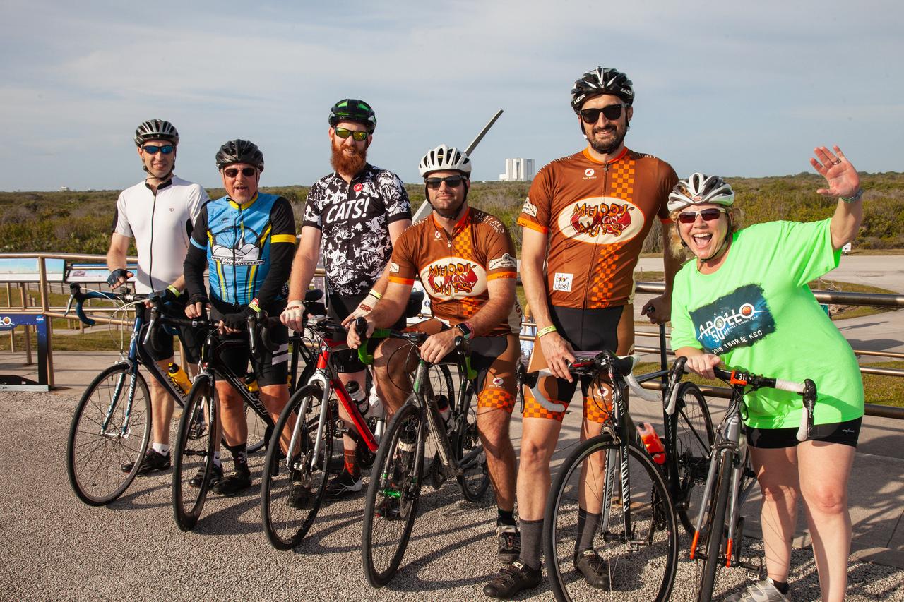 Cyclists pose for a photo with the Vehicle Assembly Building (VAB) faintly in the background during Kennedy Space Center’s annual Tour de KSC. The bicycle tour took place March 30, giving Kennedy employees and guests the opportunity to choose from three different routes that ranged from seven to 33 miles along some of the Florida spaceport’s most notable facilities such as the VAB, the Shuttle Landing Facility and historic Launch Pad 39A, among others.