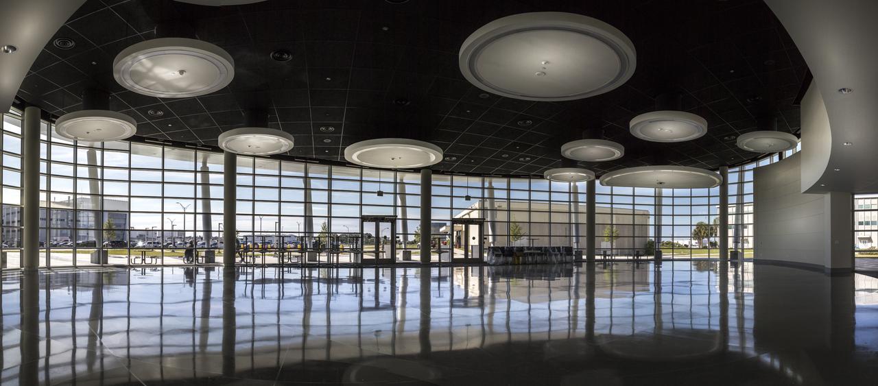 A view of the cafeteria area inside the new headquarters building on April 3, 2019, at NASA’s Kennedy Space Center in Florida. The newly constructed facility anchors the multi-user spaceport’s Central Campus. More than 500 civil service and contractor employees will be based in the 200,000-square-foot building. The facility earned the U.S. Green Building Council’s Leadership in Energy and Environmental Design (LEED) Gold designation. Features include LED lighting throughout, along with occupancy sensors to turn off unneeded lights; windows, screens and shades designed to maximize natural light; chilled beam HVAC technology reducing the need for ductwork, and more.