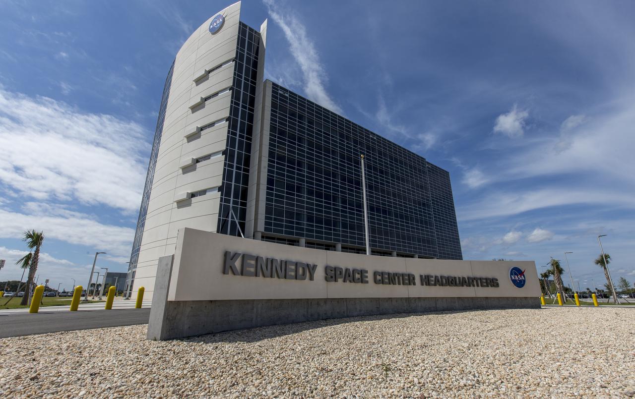 A view of the front of the new headquarters building on April 3, 2019, at NASA’s Kennedy Space Center in Florida. The newly constructed facility anchors the multi-user spaceport’s Central Campus. More than 500 civil service and contractor employees will be based in the 200,000-square-foot building. The facility earned the U.S. Green Building Council’s Leadership in Energy and Environmental Design (LEED) Gold designation. Features include LED lighting throughout, along with occupancy sensors to turn off unneeded lights; windows, screens and shades designed to maximize natural light; chilled beam HVAC technology reducing the need for ductwork, and more. 