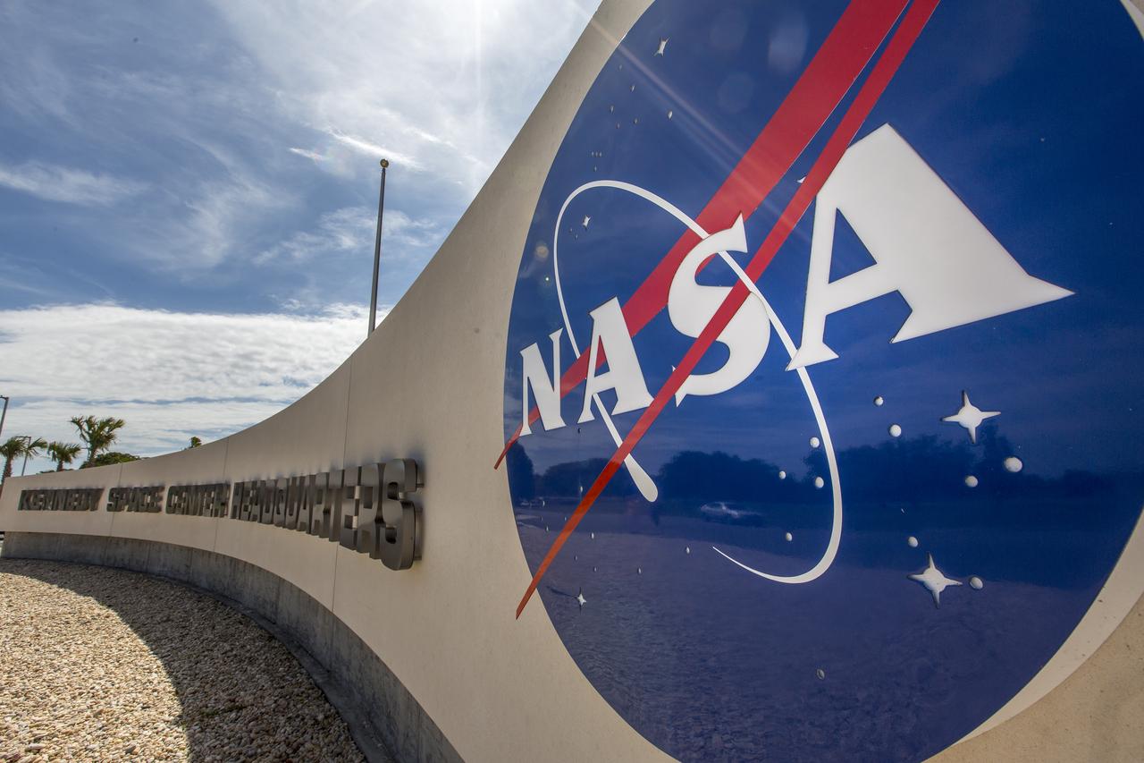 A close-up view the NASA insignia in front of the entrance to the new headquarters building on April 3, 2019, at NASA’s Kennedy Space Center in Florida. The newly constructed facility anchors the multi-user spaceport’s Central Campus. More than 500 civil service and contractor employees will be based in the 200,000-square-foot building. The facility earned the U.S. Green Building Council’s Leadership in Energy and Environmental Design (LEED) Gold designation. Features include LED lighting throughout, along with occupancy sensors to turn off unneeded lights; windows, screens and shades designed to maximize natural light; chilled beam HVAC technology reducing the need for ductwork, and more.