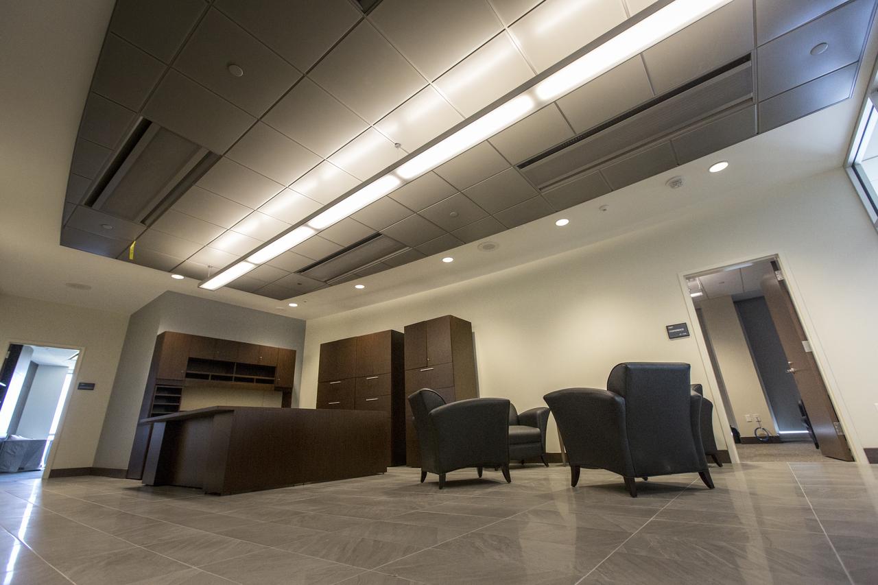 A view of the Kennedy Space Center director’s office suite on the seventh floor of the new headquarters building on April 3, 2019, at NASA’s Kennedy Space Center in Florida. The newly constructed facility anchors the multi-user spaceport’s Central Campus. More than 500 civil service and contractor employees will be based in the 200,000-square-foot building. The facility earned the U.S. Green Building Council’s Leadership in Energy and Environmental Design (LEED) Gold designation. Features include LED lighting throughout, along with occupancy sensors to turn off unneeded lights; windows, screens and shades designed to maximize natural light; chilled beam HVAC technology reducing the need for ductwork, and more. 