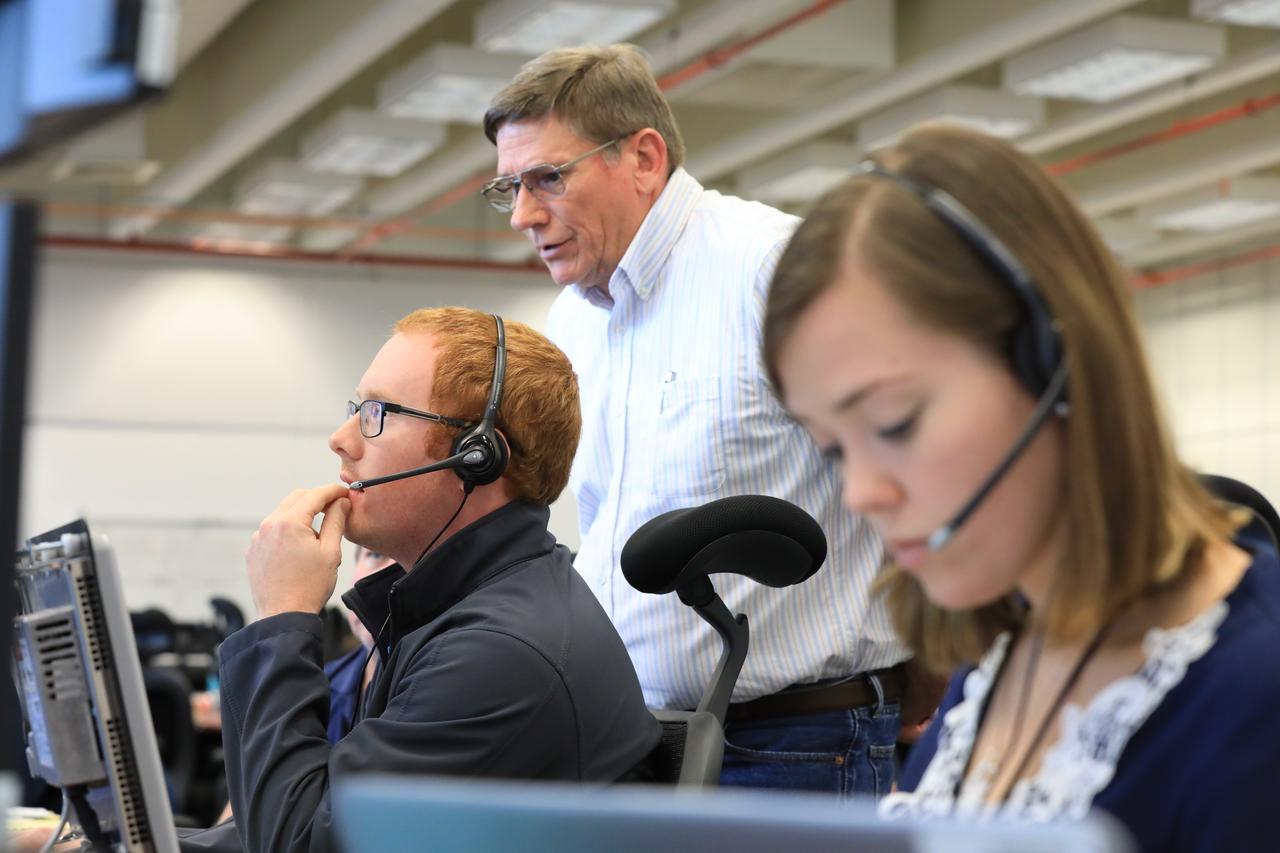 Tom Clark, standing, a manager with contractor ERC, works with Quentin Jones and Emily Hadley, both mechanical engineers for the liquid oxygen system, with ERC, during a countdown demonstration event of cryogenic propellant loading April 12, 2019, inside Firing Room 2 in the Launch Control Center at NASA’s Kennedy Space Center in Florida. The practice simulation involved loading of liquid hydrogen and liquid oxygen into the Space Launch System rocket’s core and upper stages to prepare for Exploration Mission-1 (EM-1). During the tanking exercise, the team worked through surprise issues in real-time. The practice countdown events are training opportunities coordinated by EM-1 Launch Director Charlie Blackwell-Thompson with Exploration Ground Systems.