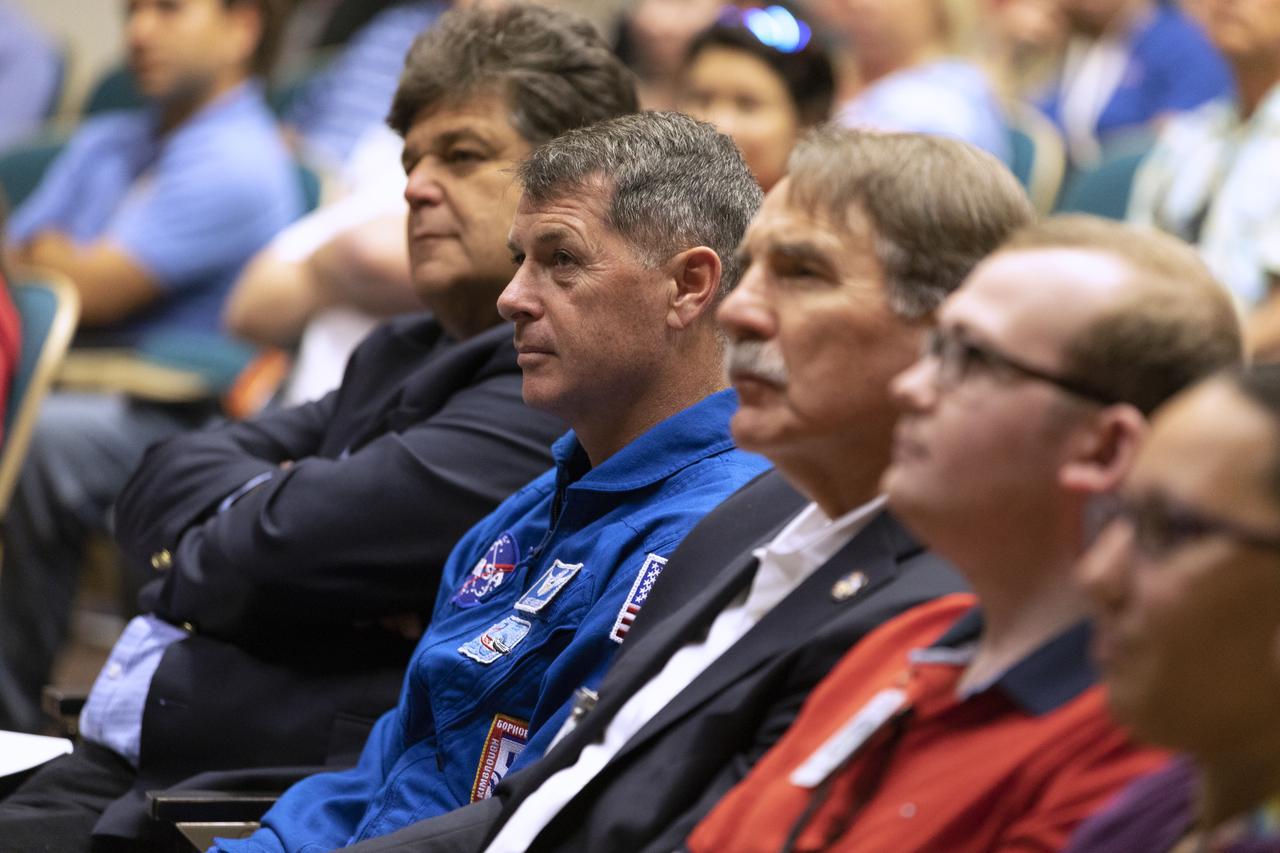 NASA astronaut Shane Kimbrough, blue flight suit, listens to a presentation in Kennedy Space Center’s Training Auditorium on April 12, 2019, during “Columbia: The Mission Continues,” an event organized by the Apollo Challenger Columbia Lessons Learned Program (ACCLLP). Kimbrough also was a speaker at the event, which is part of the Space Shuttle Columbia national tour and took place on the 38th anniversary of STS-1, the first orbital spaceflight of NASA’s Space Shuttle Program. The tour launched at Kennedy and will make its way to each of the 10 NASA centers.