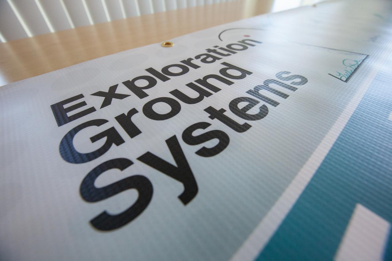 A banner signing event was held April 22, 2019, at NASA’s Kennedy Space Center in Florida, to mark the accomplishments of the Kennedy engineering team that supported the Ground Support Equipment (GSE) Subsystem Software development. This team includes the software leads, local developers, remote developers, modelers, project engineers, software quality assurance, build team members, integrators, system engineers, a chief engineer and some software managers. There are 60 unique instances of GSE Subsystem Software code. As of today, 58 of those 60 instances have completed software Level 5 Verification (L5V) and are in the process of completing Subsystem Verification & Validation.