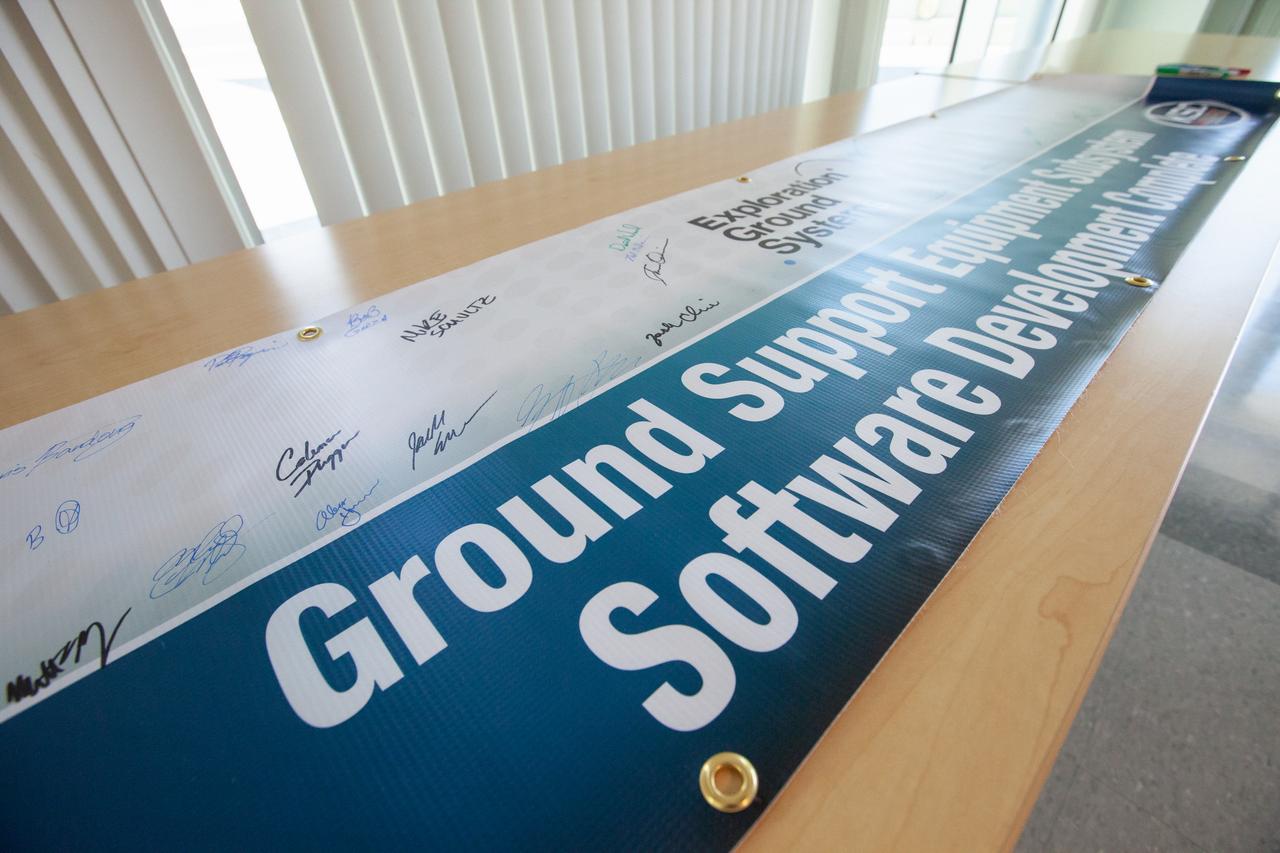A banner signing event was held April 22, 2019, at NASA’s Kennedy Space Center in Florida, to mark the accomplishments of the Kennedy engineering team that supported the Ground Support Equipment (GSE) Subsystem Software development. This team includes the software leads, local developers, remote developers, modelers, project engineers, software quality assurance, build team members, integrators, system engineers, a chief engineer and some software managers. There are 60 unique instances of GSE Subsystem Software code. As of today, 58 of those 60 instances have completed software Level 5 Verification (L5V) and are in the process of completing Subsystem Verification & Validation.