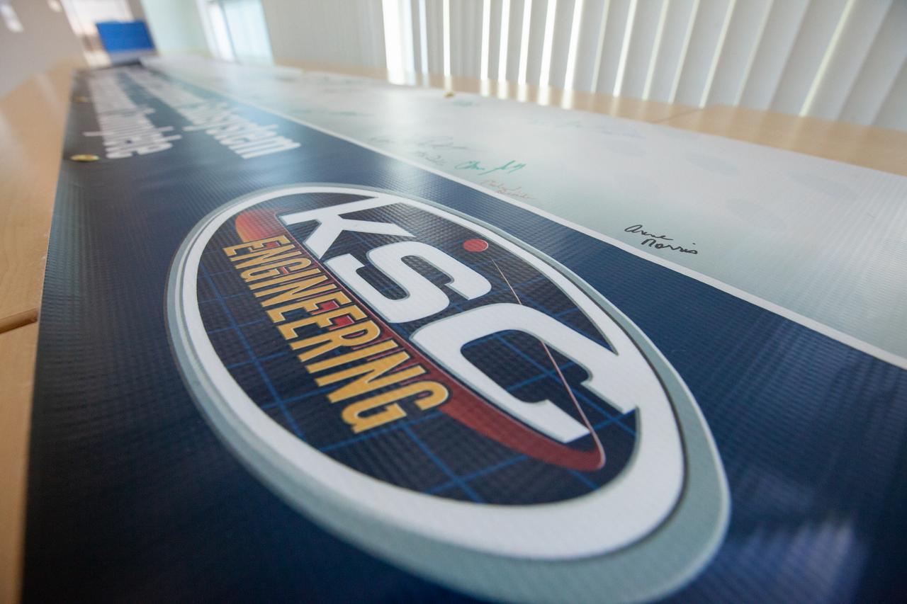 A banner signing event was held April 22, 2019, at NASA’s Kennedy Space Center in Florida, to mark the accomplishments of the Kennedy engineering team that supported the Ground Support Equipment (GSE) Subsystem Software development. This team includes the software leads, local developers, remote developers, modelers, project engineers, software quality assurance, build team members, integrators, system engineers, a chief engineer and some software managers. There are 60 unique instances of GSE Subsystem Software code. As of today, 58 of those 60 instances have completed software Level 5 Verification (L5V) and are in the process of completing Subsystem Verification & Validation.