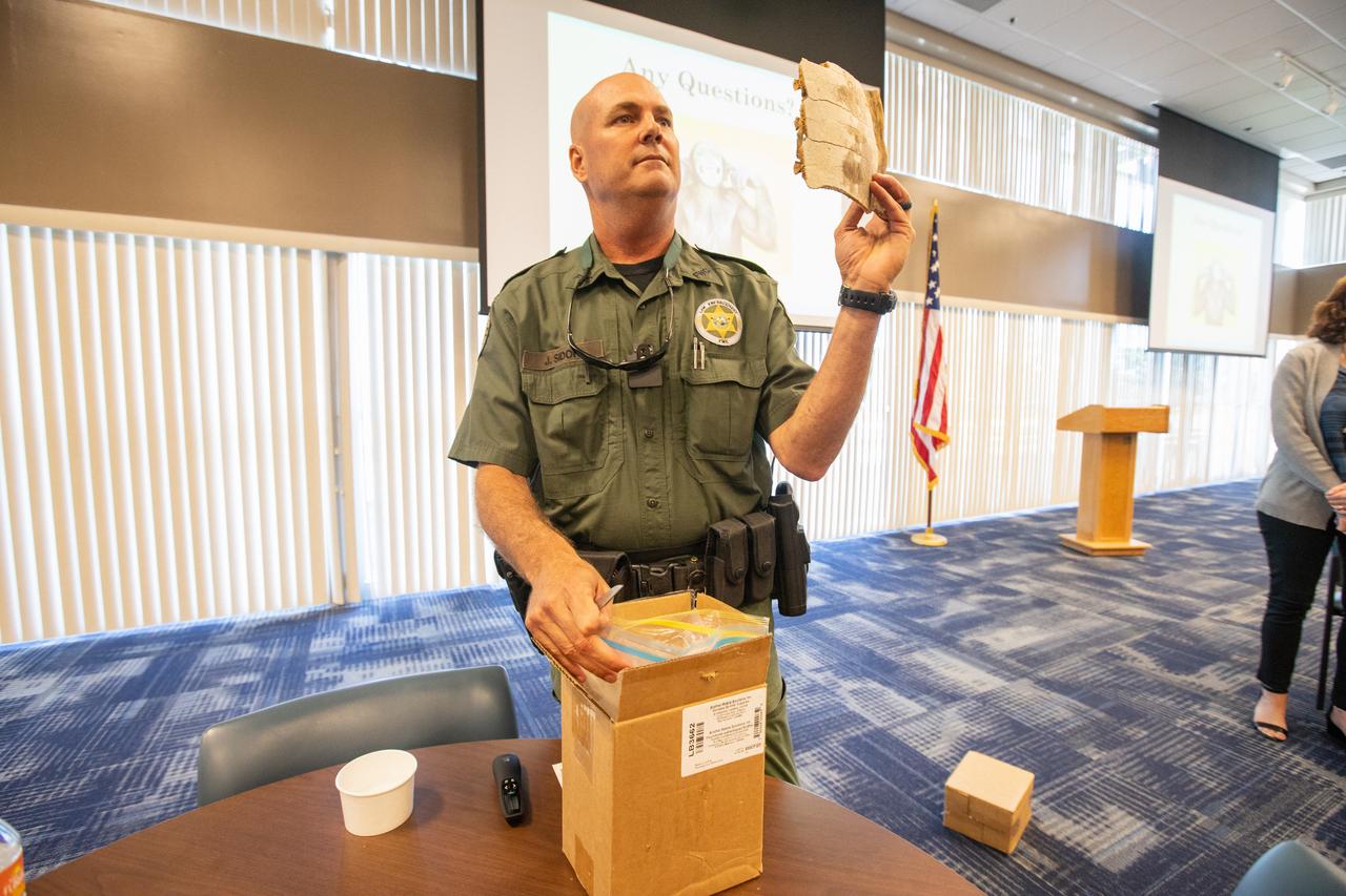 Fish and Wildlife Conservation Commission (FWC) Officer Jeff Sidor holds up a piece of turtle shell during a presentation and demonstration to Kennedy Space Center employees in the Space Station Processing Facility Conference Center on April 23, 2019. Officer Sidor brought a special K9, Harry, to demonstrate how FWC is using specially trained dogs in airports, seaports and mail facilities to detect illegal and invasive fish and wildlife species shipping into Florida. The demonstration involved Harry distinguishing which box, among many, contained the turtle shell. This lunch and learn was available for employees to attend as part of Kennedy’s Earth Day events. 