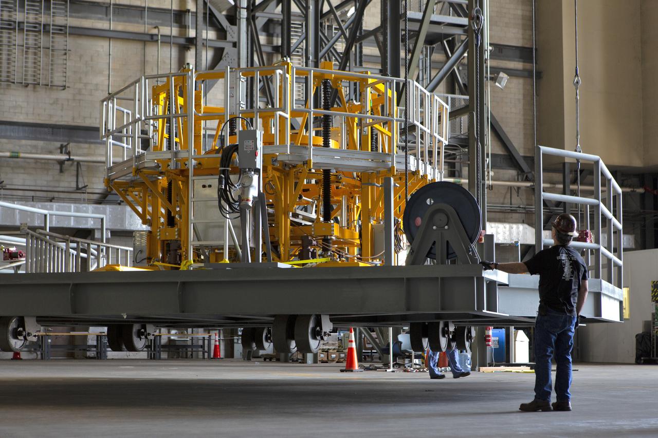 The engine vertical installer for NASA’s Space Launch System (SLS) is inside the Vehicle Assembly at NASA’s Kennedy Space Center in Florida on April 25, 2019. The engine installer is being lifted up by crane for transfer to High Bay 3. The engine installer arrived from the manufacturer, Precision Fabrication and Cleaning in Canaveral Groves, Florida. The new ground support equipment will be ready for preflight processing in the event one of the four RS-25 engines on the core stage of the SLS rocket needs to be replaced. During launch of the SLS and Orion spacecraft, the four core stage engines will provide the thrust needed to lift the rocket and Orion spacecraft off Launch Pad 39B at Kennedy for Exploration Mission-1. The uncrewed Orion will travel on a three-week test mission thousands of miles beyond the Moon and back to Earth for a splashdown in the Pacific Ocean.