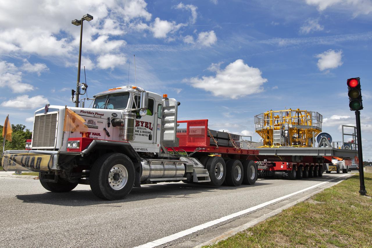 The engine vertical installer for NASA’s Space Launch System (SLS) arrives by large transport truck at NASA’s Kennedy Space Center in Florida on April 25, 2019. The engine installer arrived from the manufacturer, Precision Fabrication and Cleaning in Canaveral Groves, Florida. The new ground support equipment will be delivered to the Vehicle Assembly where it will be ready for preflight processing in the event one of the four RS-25 engines on the core stage of the SLS rocket needs to be replaced. During launch of the SLS and Orion spacecraft, the four core stage engines will provide the thrust needed to lift the rocket and Orion spacecraft off Launch Pad 39B at Kennedy for Exploration Mission-1. The uncrewed Orion will travel on a three-week test mission thousands of miles beyond the Moon and back to Earth for a splashdown in the Pacific Ocean.