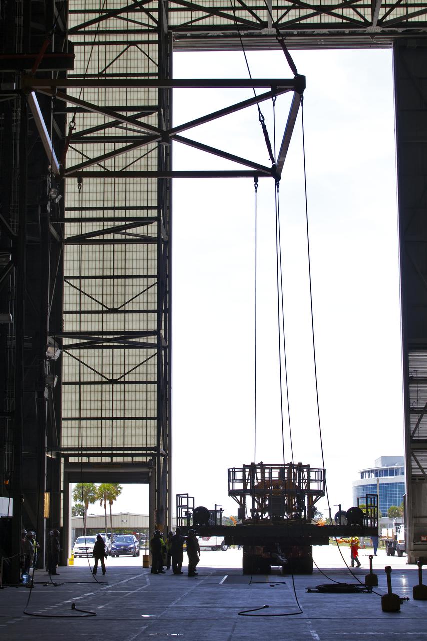 The engine vertical installer for NASA’s Space Launch System (SLS) is being lifted by crane in the Vehicle Assembly Building at NASA’s Kennedy Space Center in Florida on April 25, 2019. The engine installer arrived from the manufacturer, Precision Fabrication and Cleaning in Canaveral Groves, Florida. The new ground support equipment will be transferred into High Bay 3 where it will be ready for preflight processing in the event one of the four RS-25 engines on the core stage of the SLS rocket needs to be replaced. During launch of the SLS and Orion spacecraft, the four core stage engines will provide the thrust needed to lift the rocket and Orion spacecraft off Launch Pad 39B at Kennedy for Exploration Mission-1. The uncrewed Orion will travel on a three-week test mission thousands of miles beyond the Moon and back to Earth for a splashdown in the Pacific Ocean.