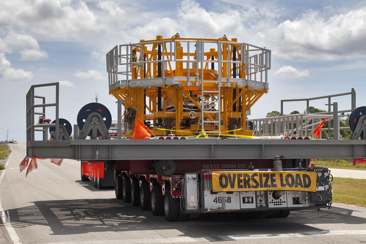 The engine vertical installer for NASA’s Space Launch System (SLS) arrives by large transport truck at NASA’s Kennedy Space Center in Florida on April 25, 2019, from the manufacturer, Precision Fabrication and Cleaning in Canaveral Groves, Florida. The new ground support equipment will be delivered to the Vehicle Assembly Building where it will be ready for preflight assembly in the event one of the four RS-25 engines on the core stage of the SLS rocket needs to be replaced. During launch of the SLS and Orion spacecraft, the four core stage engines will provide the thrust needed to lift the rocket and Orion spacecraft off Launch Pad 39B at Kennedy for Exploration Mission-1. The uncrewed Orion will travel on a three-week test mission thousands of miles beyond the Moon and back to Earth for a splashdown in the Pacific Ocean.