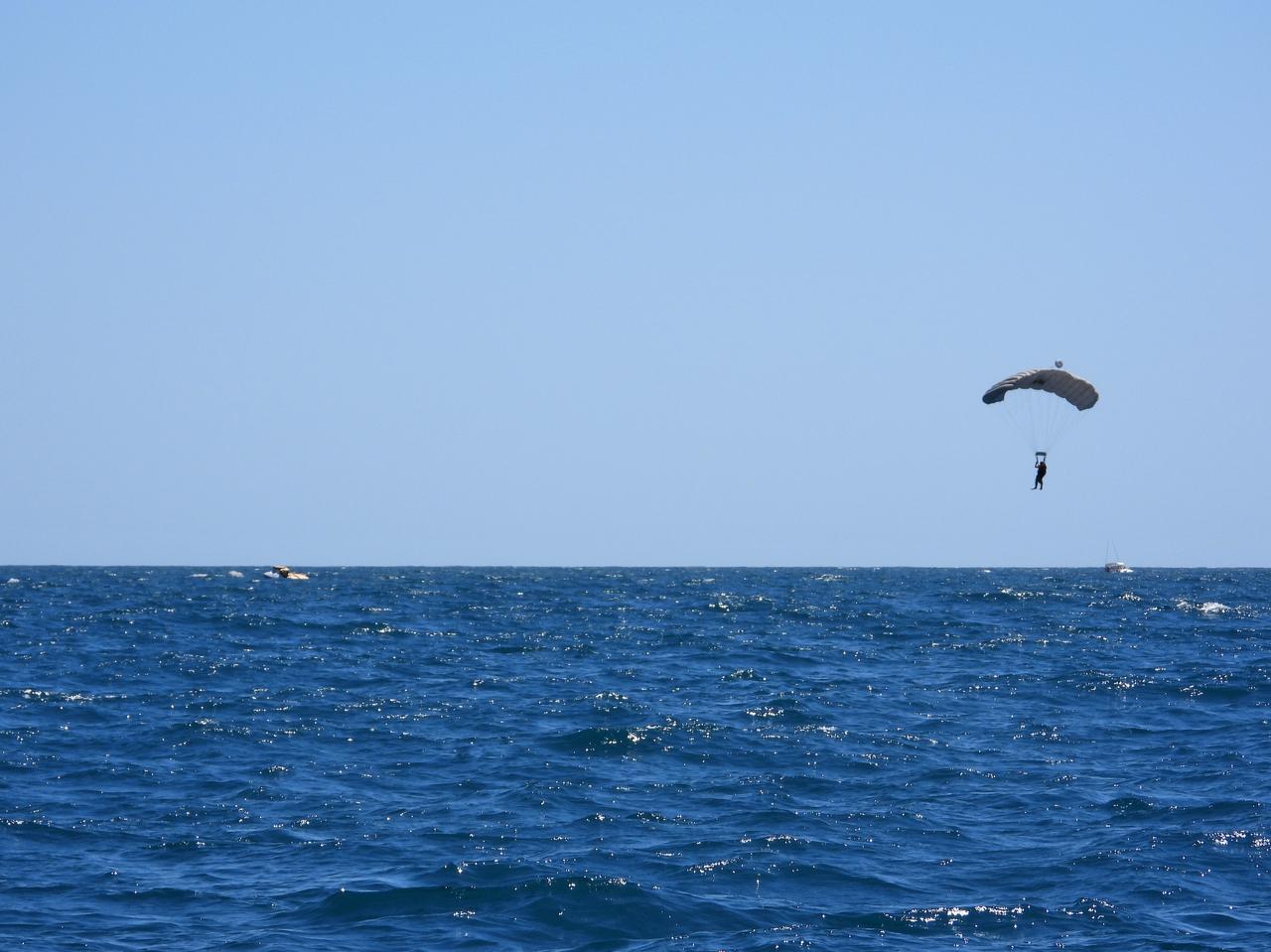 U.S. Air Force “Guardian Angel” Pararescue forces are airdropped into the Atlantic Ocean off the coast of Cape Canaveral near Kennedy Space Center in Florida to rehearse a full mission profile training exercise on April 27, 2019. The exercise included using a Boeing CST-100 Starliner training capsule to run through the necessary steps in the unlikely event of an emergency resulting in a splashdown. NASA and the Department of Defense (DoD) Human Space Flight Support Office Rescue Division conducted the training, which included rehearsing assisted egress, extracting DoD team members acting as astronauts, from the capsule and providing immediate medical treatment. This open-ocean exercise provides team members with the necessary training ahead of Boeing’s Crew Flight Test with astronauts targeted for later this year. During normal return scenarios, Boeing’s Starliner will land in a safe zone of about 15 square miles in the Western United States. Throughout the commercial crew development phases with NASA, Boeing has performed dozens of qualification tests on its parachute and airbag systems simulating conditions on land and in the water. 