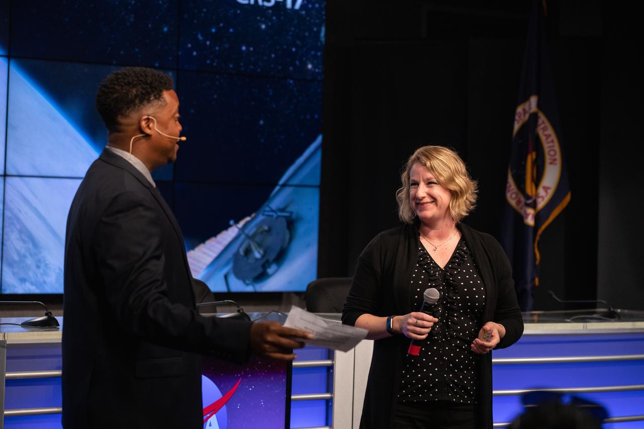 Derrick Matthews, at left, moderator with NASA Communications, introduces Dr. Lucy Low, with the National Institutes of Health, during a What’s On Board science briefing to NASA Social participants at the agency’s Kennedy Space Center in Florida on April 29, 2019. The briefing was held for SpaceX’s 17th Commercial Resupply Services (CRS-17) mission to the International Space Station. Low presented on the Tissue Chips in Space project that will test the ability of tissue chip technology to mimic how human organs work and reveal what effects microgravity has on tissue function. Headed to the space station will be lung and bone marrow chips, kidney chips, chips modeling the blood-brain barrier, and bone and cartilage chips. NASA’s Orbiting Carbon Observatory-3 (OCO-3) and Space Test Program-Houston 6 (STP-H6) are two of the experiments that also will be delivered to the space station on CRS-17. The SpaceX Falcon 9 rocket and Dragon cargo module are scheduled to launch no earlier than May 3, 2019, from Space Launch Complex 40 on Cape Canaveral Air Force Station in Florida.