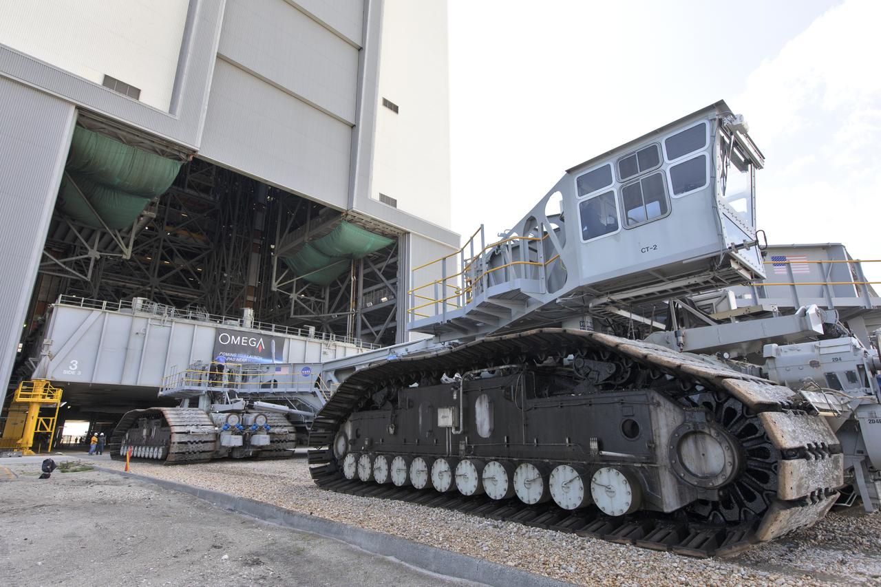 During a practice run, crawler-transporter 2 (CT-2) is at the entrance to High Bay 2 of the Vehicle Assembly Building (VAB) at NASA’s Kennedy Space Center in Florida on May 1, 2019. CT-2 entered High Bay 2, and picked up the space shuttle-era mobile launch platform-3 (MLP-3). The VAB is getting its first commercial tenant. Northrop Grumman signed a Reimbursable Space Act Agreement with NASA for use of the facilities. The company will assemble and test its new OmegA rocket inside the massive facility’s High Bay 2. The company also will modify MLP-3 to serve as the launch vehicle’s assembly and launch platform. Northrop Grumman is developing the OmegA rocket, an intermediate/heavy-class launch vehicle, as part of a launch services agreement with the U.S. Air Force.