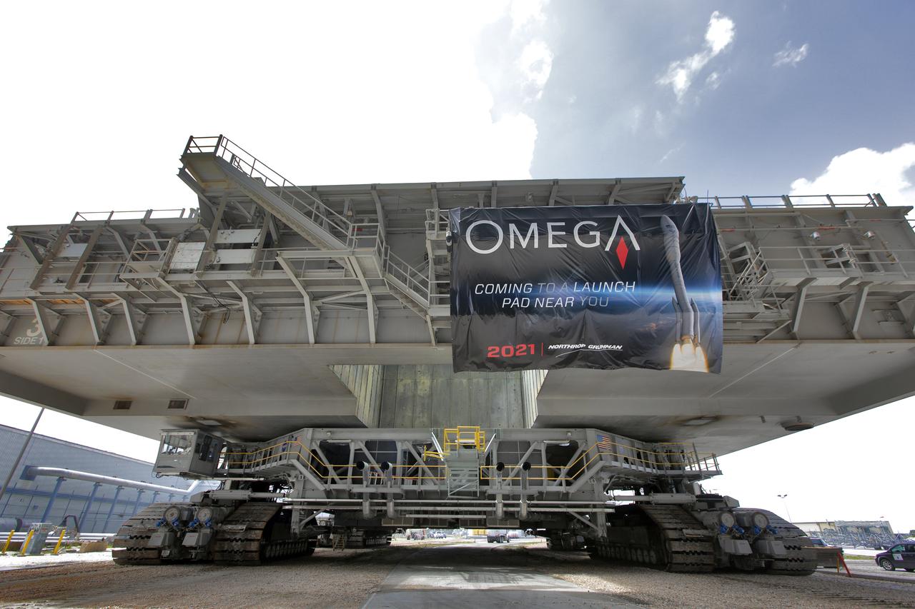 During a practice run, crawler-transporter 2 (CT-2), with the space shuttle-era mobile launch platform-3 (MLP-3) on top, has exited High Bay 2 of the Vehicle Assembly Building (VAB) and moves slowly along the crawlerway at NASA’s Kennedy Space Center in Florida on May 1, 2019. The VAB is getting its first commercial tenant. Northrop Grumman signed a Reimbursable Space Act Agreement with NASA for use of the facilities. The company will assemble and test its new OmegA rocket inside the massive facility’s High Bay 2. The company also will modify MLP-3 to serve as the launch vehicle’s assembly and launch platform. Northrop Grumman is developing the OmegA rocket, an intermediate/heavy-class launch vehicle, as part of a launch services agreement with the U.S. Air Force.