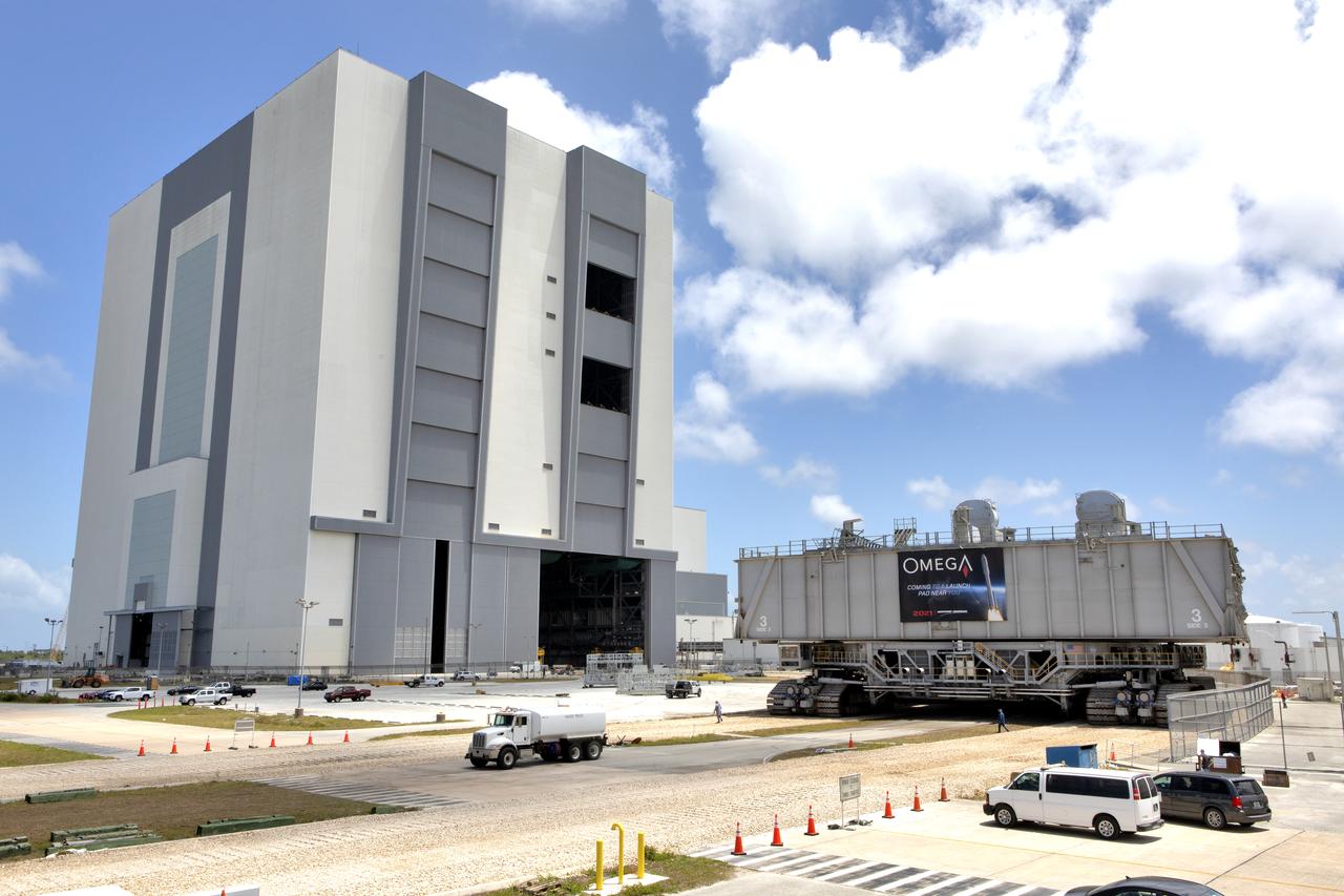 During a practice run, crawler-transporter 2 (CT-2), with the space shuttle-era mobile launch platform-3 (MLP-3) on top, has exited High Bay 2 of the Vehicle Assembly Building (VAB) and moves slowly along the crawlerway at NASA’s Kennedy Space Center in Florida on May 1, 2019. The VAB is getting its first commercial tenant. Northrop Grumman signed a Reimbursable Space Act Agreement with NASA for use of the facilities. The company will assemble and test its new OmegA rocket inside the massive facility’s High Bay 2. The company also will modify MLP-3 to serve as the launch vehicle’s assembly and launch platform. Northrop Grumman is developing the OmegA rocket, an intermediate/heavy-class launch vehicle, as part of a launch services agreement with the U.S. Air Force.