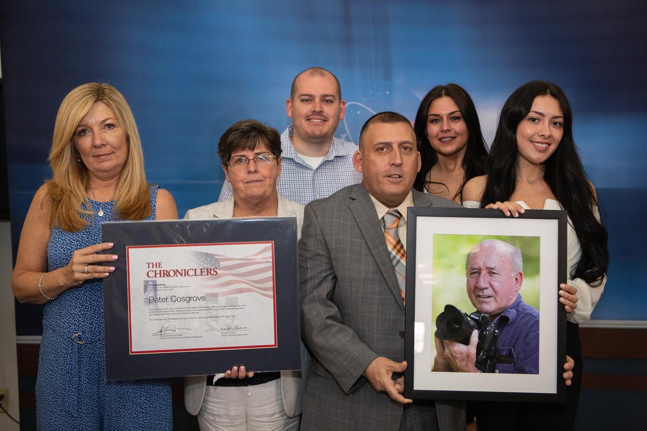 Peter Cosgrove was honored as a Chronicler during a ceremony May 3, 2019, at Kennedy Space Center’s NASA News Center in Florida. Cosgrove passed away earlier in 2019, and his award was accepted by members of his family on his behalf. Cosgrove was a photographer with the Associated Press, and his career in photojournalism spanned 50 years. He covered four Apollo Moon mission crew recoveries and more than 100 space shuttle launches. Also inducted as members were journalists Jim Banke and Todd Halvorson, and radio broadcaster Vic Ratner. They were selected by a committee of their peers on March 25. The Chroniclers recognizes retirees of the news and communications business who have helped spread news of American space exploration from Kennedy for 10 years or more. 