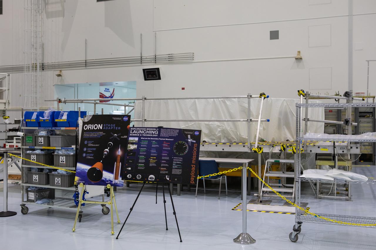 The Orion stage adapter for Artemis 1 is in view, wrapped in a protective covering, in this photograph taken on May 16, 2019, inside the high bay in the Space Station Processing Facility (SSPF) at NASA's Kennedy Space Center in Florida. The center is celebrating the SSPF’s 25th anniversary. The facility was built to process elements for the International Space Station. Now it is providing support for current and future NASA and commercial provider programs, including Commercial Resupply Services, Artemis 1, sending the first woman and next man to the Moon, and deep space destinations including Mars.