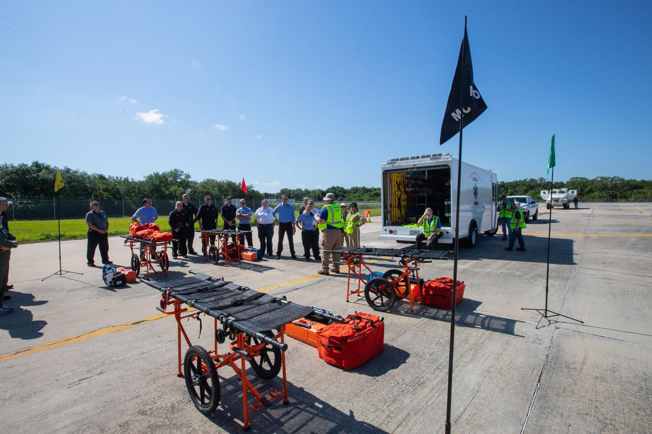 Kennedy Space Center personnel and American Medical Response (AMR) contractor paramedics gather at the Florida spaceport’s Shuttle Landing Facility on May 17, 2019, for a medical support training course. The course was designed to familiarize the AMR paramedics with the center’s Triage Forces deployment, which included medical team members, fire/rescue personnel, environmental health specialists and flight operations crew members, as well as a helicopter, Mine Resistant Ambush Protected (MRAP) tactical vehicle, fire pumper truck and triage vehicles. The AMR paramedics will assist the agency in contingency planning for the return of human spaceflight from Kennedy.