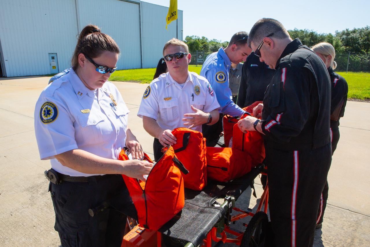 Kennedy Space Center personnel and American Medical Response (AMR) contractor paramedics gather at the Florida spaceport’s Shuttle Landing Facility on May 17, 2019, for a medical support training course. The course was designed to familiarize the AMR paramedics with the center’s Triage Forces deployment, which included medical team members, fire/rescue personnel, environmental health specialists and flight operations crew members, as well as a helicopter, Mine Resistant Ambush Protected (MRAP) tactical vehicle, fire pumper truck and triage vehicles. The AMR paramedics will assist the agency in contingency planning for the return of human spaceflight from Kennedy.