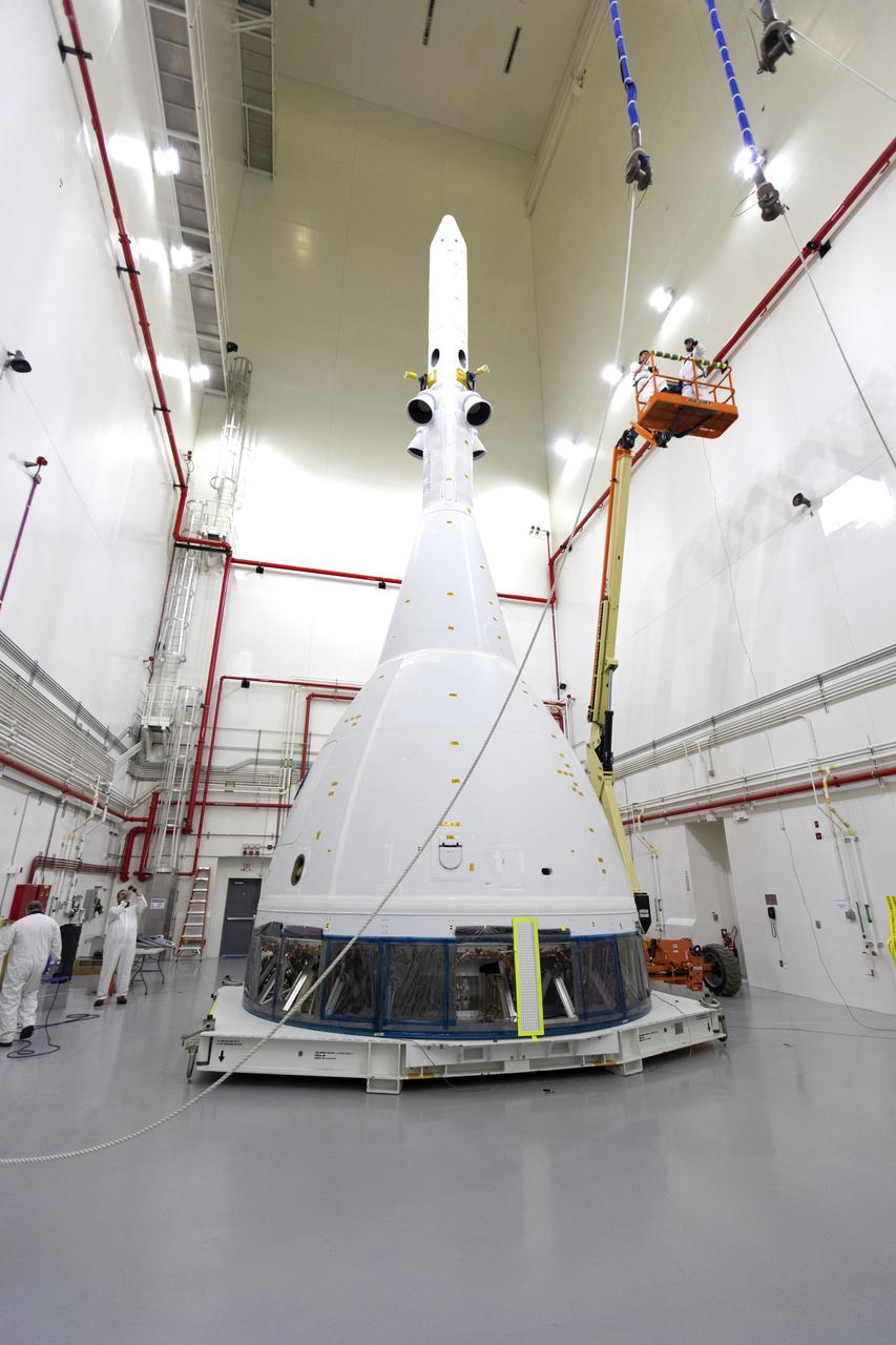Inside the Launch Abort System Facility (LASF) at NASA’s Kennedy Space Center in Florida, workers are completing the integration of a test version of the Orion crew module with the Launch Abort System (LAS) on May 18, 2019. The test vehicle and the LAS will be used for the Orion Ascent Abort-2 (AA-2) Flight Test. AA-2 is a full-stress test of the LAS, planned for July 2. AA-2 will launch from Space Launch Complex 46, carrying a fully functional LAS and a 22,000-pound Orion test vehicle to an altitude of 31,000 feet and traveling at more than 1,000 miles an hour. The test will verify the LAS can steer the crew module and astronauts aboard to safety if an emergency occurs during ascent on the Space Launch System (SLS) rocket. NASA's Orion and Exploration Ground Systems programs, contractors Jacob's, Lockheed Martin and Northrop Grumman, in conjunction with the Air Force Space and Missile Center's Launch Operations branch and the 45th Space Wing are performing flight operations for AA-2.