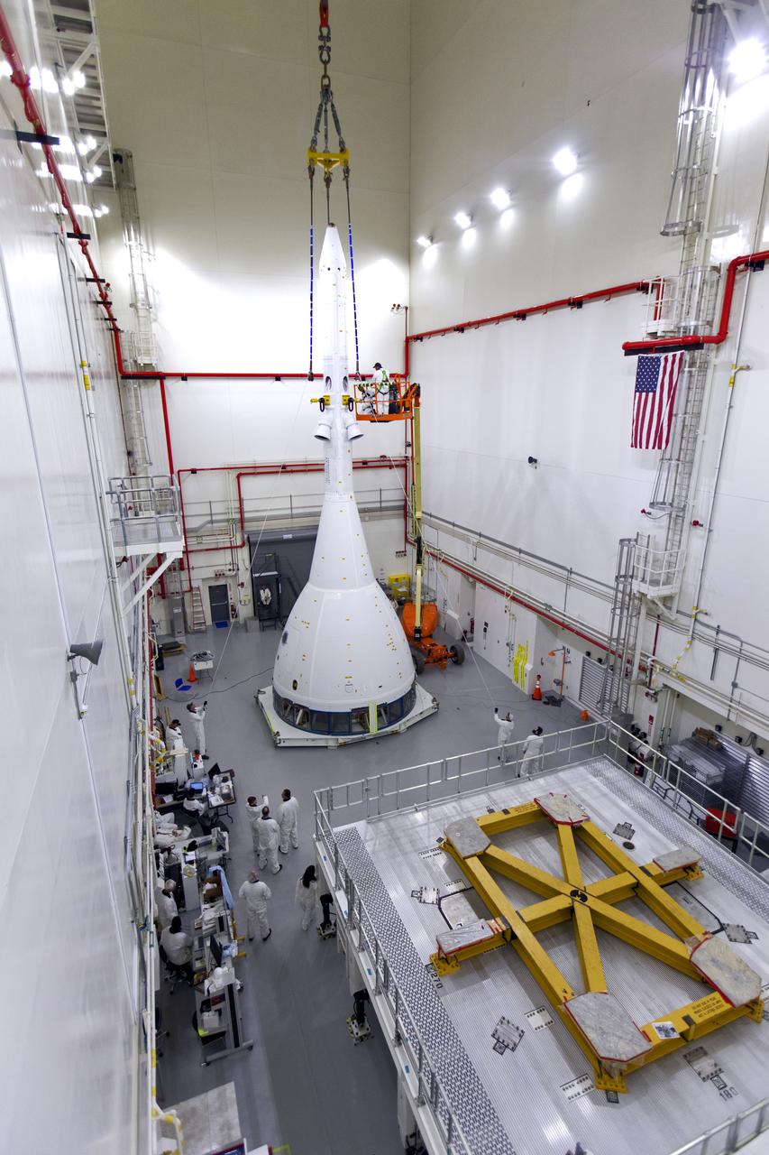 Inside the Launch Abort System Facility (LASF) at NASA’s Kennedy Space Center in Florida, workers are completing the integration of a test version of the Orion crew module with the Launch Abort System (LAS) on May 18, 2019. The test vehicle and the LAS will be used for the Orion Ascent Abort-2 (AA-2) Flight Test. AA-2 is a full-stress test of the LAS, planned for July 2. AA-2 will launch from Space Launch Complex 46, carrying a fully functional LAS and a 22,000-pound Orion test vehicle to an altitude of 31,000 feet and traveling at more than 1,000 miles an hour. The test will verify the LAS can steer the crew module and astronauts aboard to safety if an emergency occurs during ascent on the Space Launch System (SLS) rocket. NASA's Orion and Exploration Ground Systems programs, contractors Jacob's, Lockheed Martin and Northrop Grumman, in conjunction with the Air Force Space and Missile Center's Launch Operations branch and the 45th Space Wing are performing flight operations for AA-2.