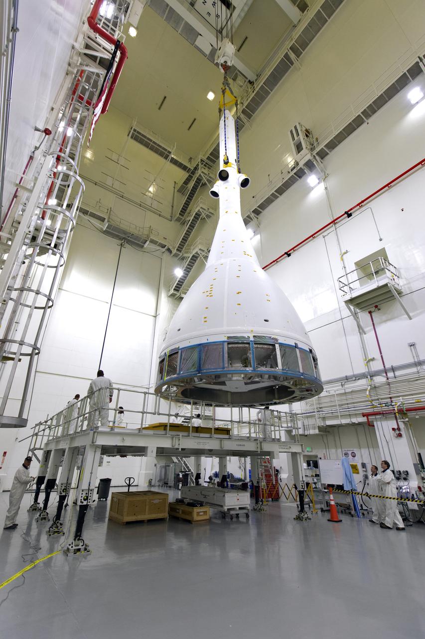 Inside the Launch Abort System Facility (LASF) at NASA’s Kennedy Space Center in Florida, a test version of the Orion crew module has been integrated with the Launch Abort System (LAS) on May 18, 2019. It is being lifted by crane for transfer to a KAMAG transporter. The test vehicle and the LAS will be used for the Orion Ascent Abort-2 (AA-2) Flight Test. AA-2 is a full-stress test of the LAS, planned for July 2. AA-2 will launch from Space Launch Complex 46, carrying a fully functional LAS and a 22,000-pound Orion test vehicle to an altitude of 31,000 feet and traveling at more than 1,000 miles an hour. The test will verify the LAS can steer the crew module and astronauts aboard to safety if an emergency occurs during ascent on the Space Launch System (SLS) rocket. NASA's Orion and Exploration Ground Systems programs, contractors Jacob's, Lockheed Martin and Northrop Grumman, in conjunction with the Air Force Space and Missile Center's Launch Operations branch and the 45th Space Wing are performing flight operations for AA-2.