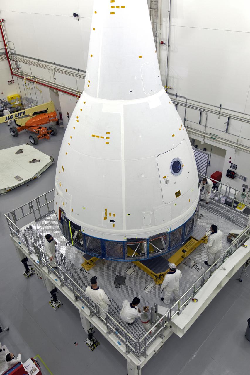Inside the Launch Abort System Facility (LASF) at NASA’s Kennedy Space Center in Florida, workers are completing the integration of a test version of the Orion crew module with the Launch Abort System (LAS) on May 18, 2019. The test vehicle and the LAS will be used for the Orion Ascent Abort-2 (AA-2) Flight Test. AA-2 is a full-stress test of the LAS, planned for July 2. AA-2 will launch from Space Launch Complex 46, carrying a fully functional LAS and a 22,000-pound Orion test vehicle to an altitude of 31,000 feet and traveling at more than 1,000 miles an hour. The test will verify the LAS can steer the crew module and astronauts aboard to safety if an emergency occurs during ascent on the Space Launch System (SLS) rocket. NASA's Orion and Exploration Ground Systems programs, contractors Jacob's, Lockheed Martin and Northrop Grumman, in conjunction with the Air Force Space and Missile Center's Launch Operations branch and the 45th Space Wing are performing flight operations for AA-2.