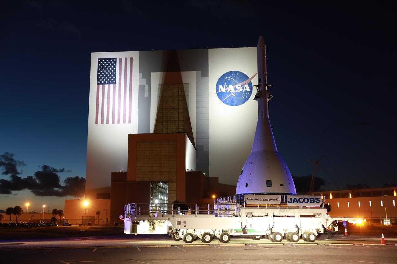 The vehicle for Orion’s Ascent Abort-2 (AA-2) fight test passes by the Vehicle Assembly Building at NASA’s Kennedy Space Center in Florida on its 21.5-mile-trek to Space Launch Complex 46 at Cape Canaveral Air Force Station on May 22, 2019. During AA-2, a test version of Orion will launch on a booster to more than six miles in altitude, where Orion’s launch abort system will pull the capsule away to demonstrate it can keep a future crew inside safe if an emergency occurs during ascent on the Space Launch System rocket. The AA-2 elements will be stacked together at the launch pad over the next several weeks. The launch is planned for July 2 and is a critical safety test that helps pave the way for Artemis missions near the Moon, and will enable astronauts to set foot on the lunar surface by 2024.