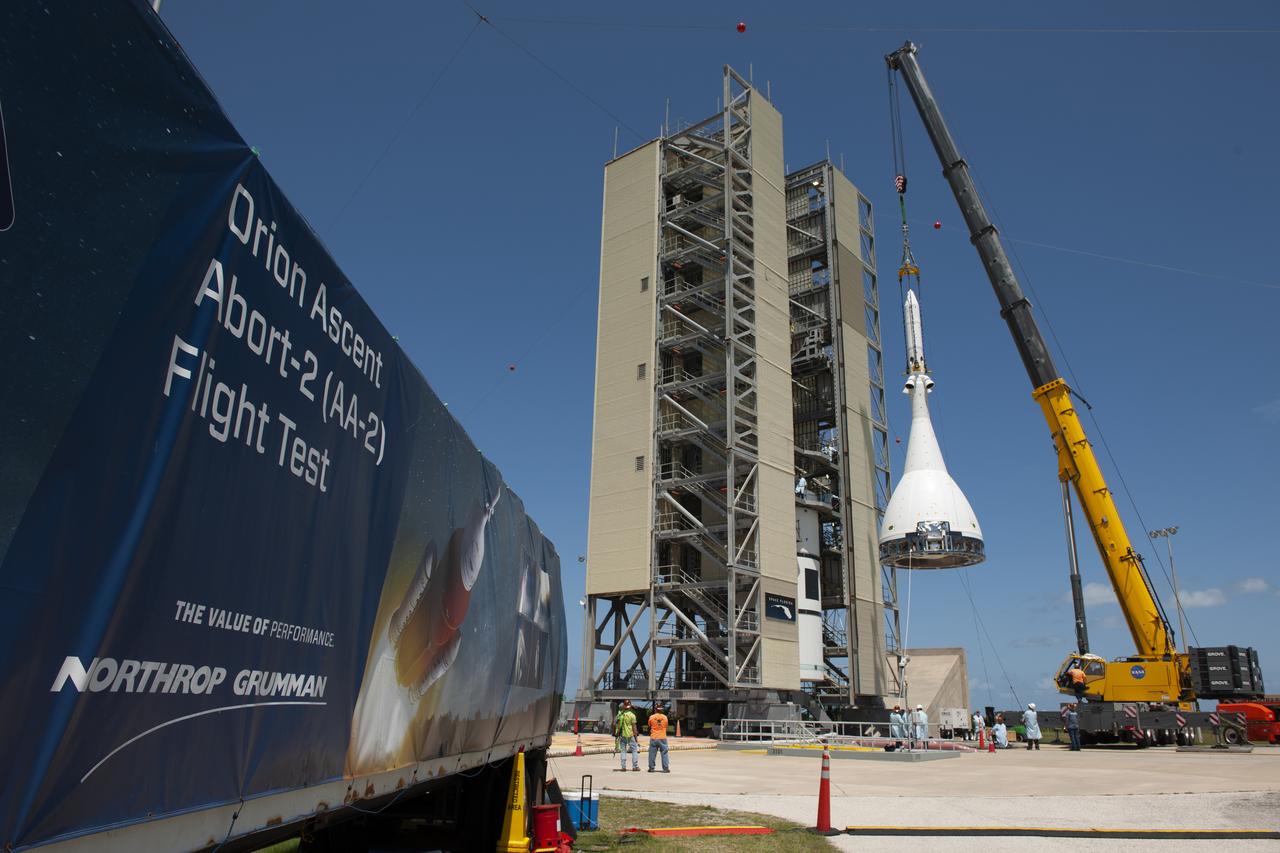 The test version of Orion attached to the Launch Abort System for the Ascent Abort-2 (AA-2) flight test is moved by crane into the vertical integration facility at Space Launch Complex 46 at Cape Canaveral Air Force Station in Florida on May 23, 2019. The flight test article will be stacked atop the booster, which was procured by the U.S. Air Force and manufactured by Northrop Grumman. During AA-2, targeted for July 2, the LAS with Orion will launch on the booster more than six miles in altitude, where Orion’s launch abort system will pull the capsule and its crew away to safety if an emergency occurs during ascent on the Space Launch System rocket. AA-2 is a critical safety test that helps pave the way for Artemis missions near the Moon, and will enable astronauts to set foot on the lunar surface by 2024.