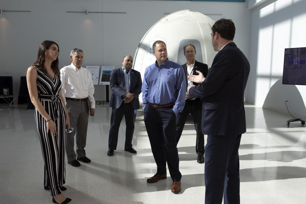 NASA Administrator Jim Bridenstine, second from right, in the blue shirt, tours the Blue Origin facilities near the agency’s Kennedy Space Center in Florida on May 23, 2019. Bridenstine viewed the New Shepard booster and crew capsule that flew to space and back five times.