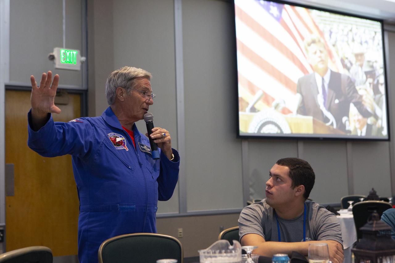 Retired NASA astronaut John Blaha talks to Swarmathon University Challenge students and their mentors during a Dine with an Astronaut event at the Kennedy Space Center Visitor Complex in Florida on June 12, 2019. Students and mentors from some of the Swarmathon teams were at Kennedy to participate in a student/mentor panel, hear from speakers, get a behind-the-scenes tour of Kennedy Space Center, dine with an astronaut and receive awards. For the challenge, university students developed algorithms for robotic swarms that are robust and adaptable like the foraging strategies of ant colonies. The fourth and final Swarmathon challenge was a combined virtual and physical competition hosted by the University of New Mexico.