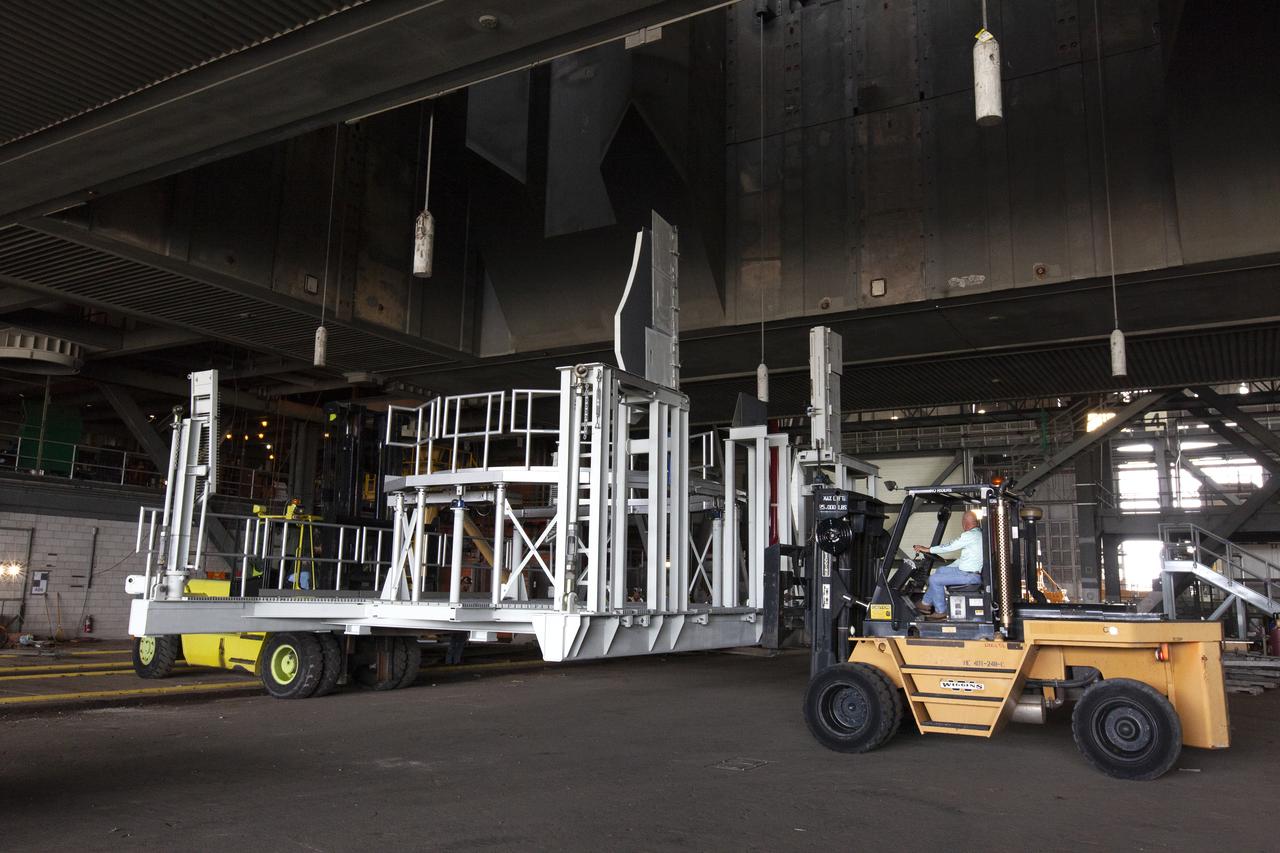 The engine service platform that will provide access to the core stage of the Space Launch System (SLS) rocket arrives in High Bay 3 of the Vehicle Assembly Building at NASA’s Kennedy Space Center in Florida on June 14, 2019. The large work platform is designed to provide unrestricted access to the RS-25 engines on the SLS core stage from the ML. The service platform will be used for Artemis 1 and subsequent missions. For Artemis 1, the Orion spacecraft will launch atop the SLS rocket from Launch Pad 39B and begin an approximately three-week mission that will send Orion thousands of miles beyond the Moon. Exploration Ground Systems is overseeing work on the ML.