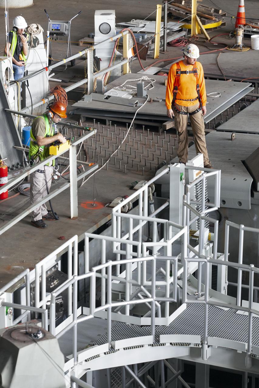 Workers with Bragg Crane and Rigging prepare for the lift of the engine service platform that will provide access to the core stage of the Space Launch System (SLS) rocket on the mobile (ML) in High Bay 3 of the Vehicle Assembly Building at NASA’s Kennedy Space Center in Florida on June 18, 2019. The large work platform is designed to provide unrestricted access to the RS-25 engines on the SLS core stage from the ML. The service platform will be used for Artemis 1 and subsequent missions. For Artemis 1, the Orion spacecraft will launch atop the SLS rocket from Launch Pad 39B and begin an approximately three-week mission that will send Orion thousands of miles beyond the Moon. Exploration Ground Systems is overseeing work on the ML.