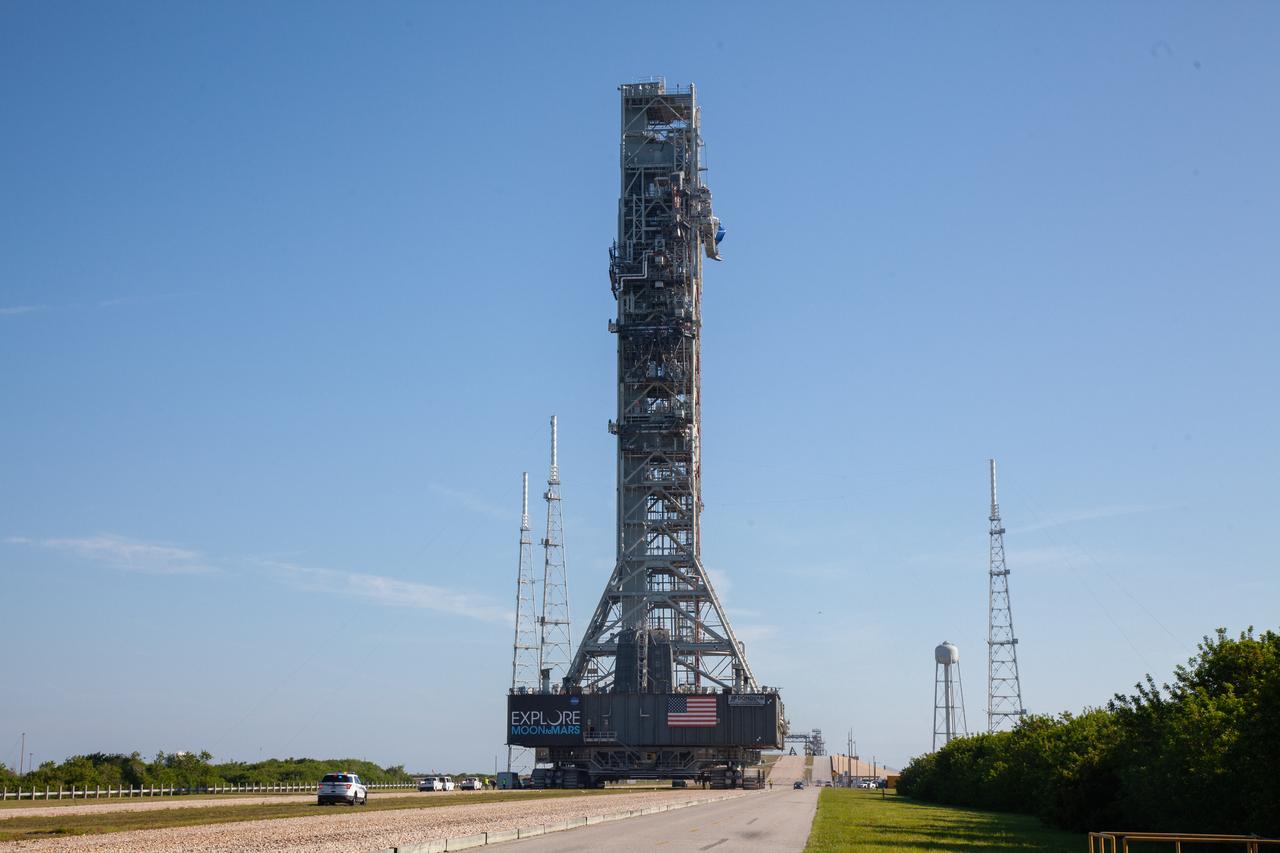 On June 27, 2019, Exploration Ground Systems’ mobile launcher, atop crawler-transporter 2, approaches Kennedy Space Center’s Launch Complex 39B in Florida, where it will remain for the summer, undergoing final testing and checkouts. The mobile launcher departed from the Vehicle Assembly Building at midnight on June 27 for the 10-hour journey to the pad. Its next roll to the pad will be with the agency’s Space Launch System rocket and Orion spacecraft in preparation for the launch of Artemis 1. 