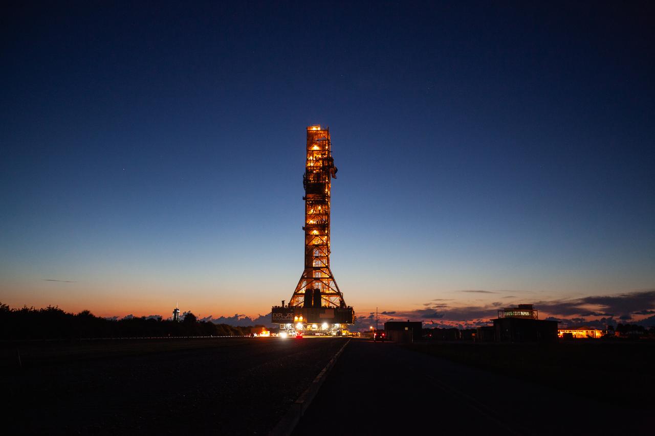 With a sunrise serving as the backdrop, Exploration Ground Systems’ mobile launcher makes its last solo trek to Kennedy Space Center’s Launch Complex 39B in Florida on June 27, 2019. It will remain there for the summer, undergoing final testing and checkouts. The mobile launcher departed from the Vehicle Assembly Building at midnight on June 27 for the 10-hour journey to the pad. Its next roll to the pad will be with the agency’s Space Launch System rocket and Orion spacecraft in preparation for the launch of Artemis 1. 