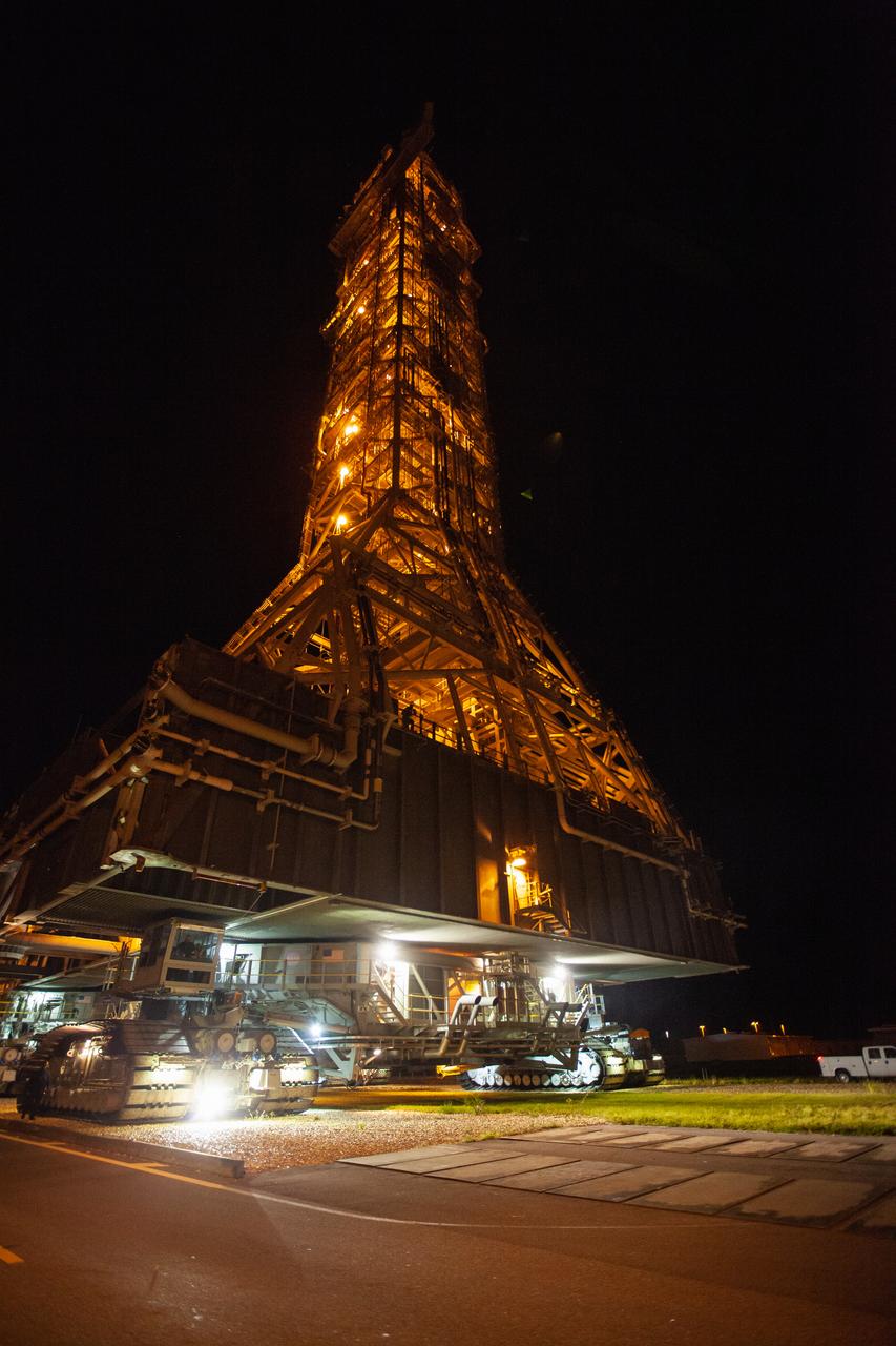 Exploration Ground Systems’ mobile launcher is illuminated in the night as it makes its last solo trek to Kennedy Space Center’s Launch Complex 39B in Florida on June 27, 2019. The mobile launcher departed from the Vehicle Assembly Building at midnight on June 27 for the 10-hour journey to the pad, where it will remain for the summer, undergoing final testing and checkouts. Its next roll to the pad will be with the agency’s Space Launch System rocket and Orion spacecraft in preparation for the launch of Artemis 1.