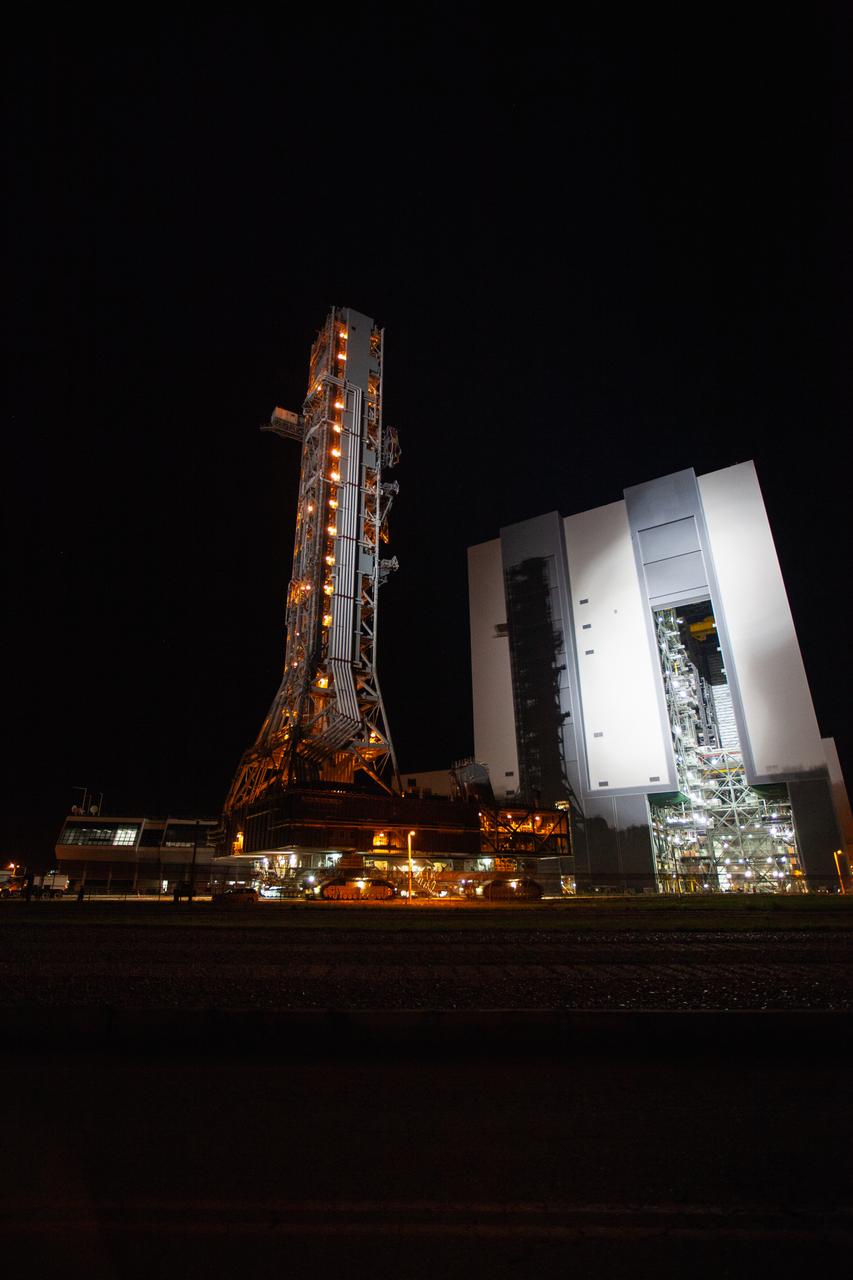 Exploration Ground Systems’ mobile launcher departs from Kennedy Space Center’s Vehicle Assembly Building (VAB) on June 27, 2019, for its final solo trek to Launch Complex 39B in Florida. The mobile launcher departed from the VAB at midnight for the 10-hour journey to the pad, where it will remain for the summer, undergoing final testing and checkouts. Its next roll to the pad will be with the agency’s Space Launch System rocket and Orion spacecraft in preparation for the launch of Artemis 1. 