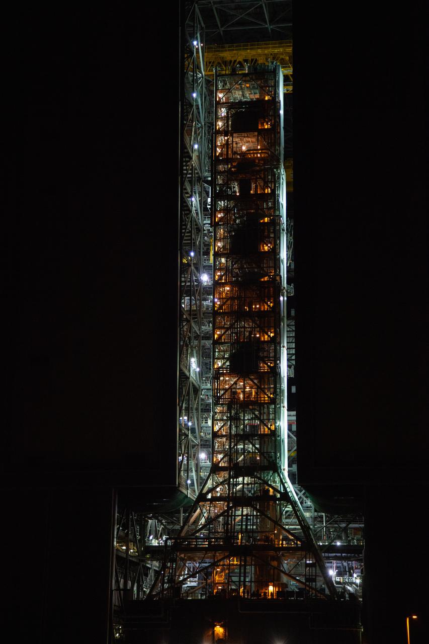 Exploration Ground Systems’ mobile launcher is illuminated in the night as it makes its last solo trek to Kennedy Space Center’s Launch Complex 39B in Florida on June 27, 2019. The mobile launcher departed from the Vehicle Assembly Building at midnight on June 27 for the 10-hour journey to the pad, where it will remain for the summer, undergoing final testing and checkouts. Its next roll to the pad will be with the agency’s Space Launch System rocket and Orion spacecraft in preparation for the launch of Artemis 1. 