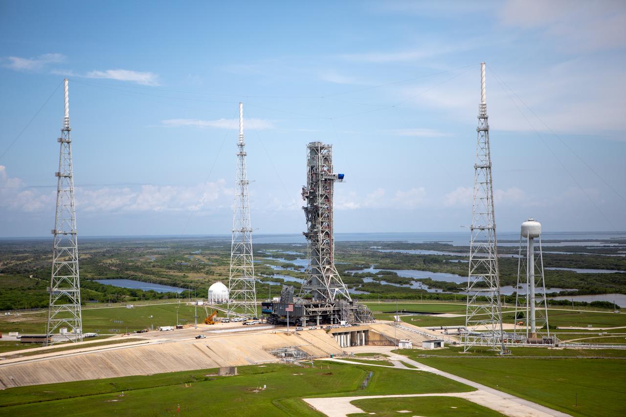 An aerial view of Launch Complex 39B with Exploration Ground Systems’ mobile launcher for the Artemis 1 mission on the pad. The mobile launcher, atop crawler-transporter 2, made its final solo trek from the Vehicle Assembly Building on June 27, 2019, and arrived on the surface of pad B on June 28, 2019, at NASA’s Kennedy Space Center in Florida. The mobile launcher will remain at the pad over the summer, undergoing final testing and checkouts. Its next roll to the pad will be with the agency’s Space Launch System rocket and Orion spacecraft in preparation for the launch of Artemis 1.