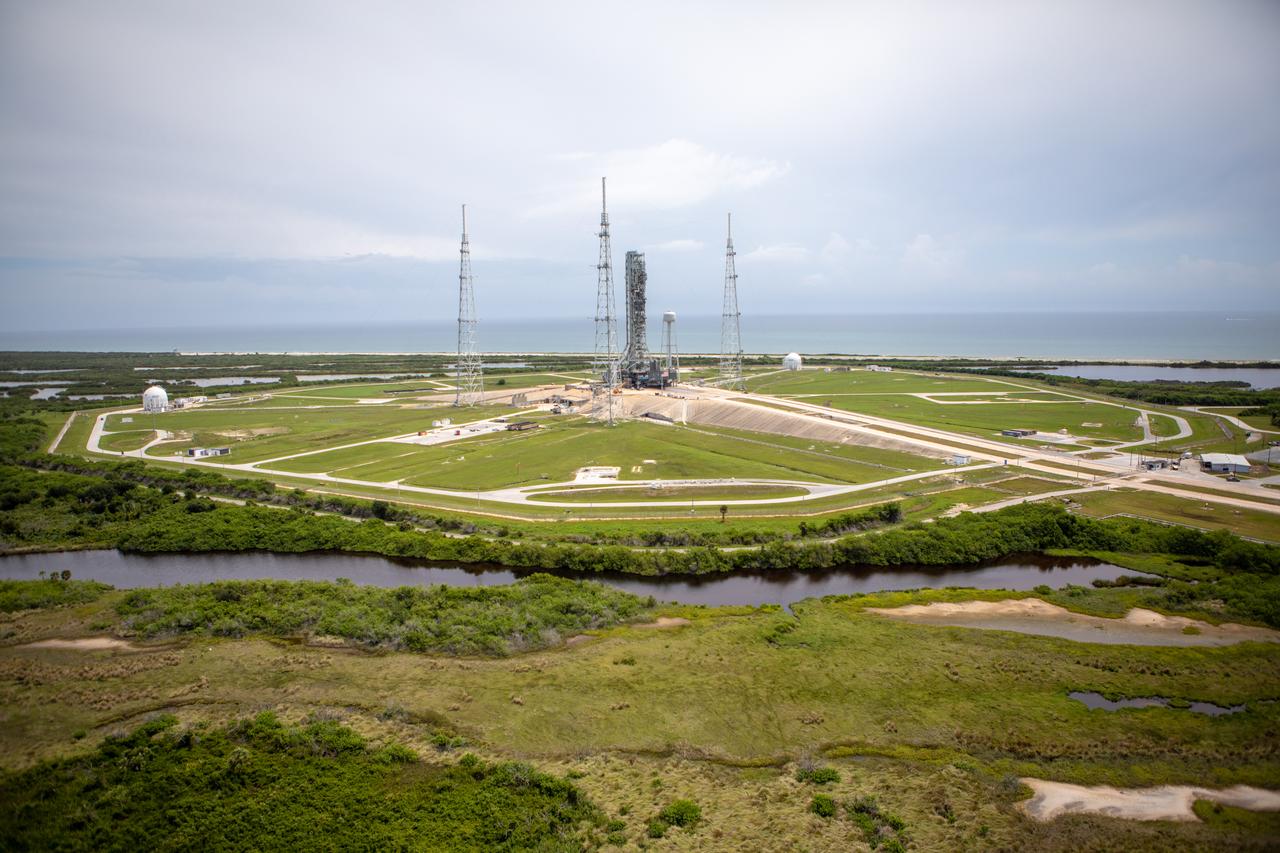 An aerial view of Launch Complex 39B with Exploration Ground Systems’ mobile launcher for the Artemis 1 mission on the pad. The mobile launcher, atop crawler-transporter 2, made its final solo trek from the Vehicle Assembly Building on June 27, 2019, and arrived on the surface of pad B on June 28, 2019, at NASA’s Kennedy Space Center in Florida. The mobile launcher will remain at the pad over the summer, undergoing final testing and checkouts. Its next roll to the pad will be with the agency’s Space Launch System rocket and Orion spacecraft in preparation for the launch of Artemis 1.